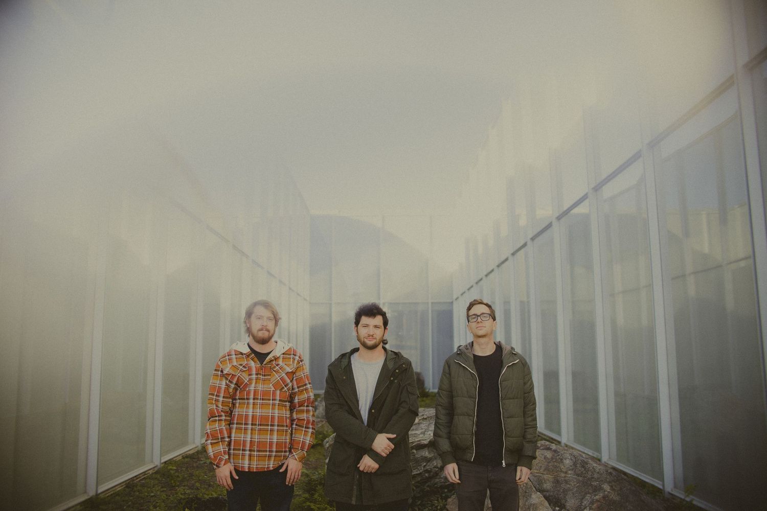Group photo taken on a foggy day with industrial buildings in the background.
