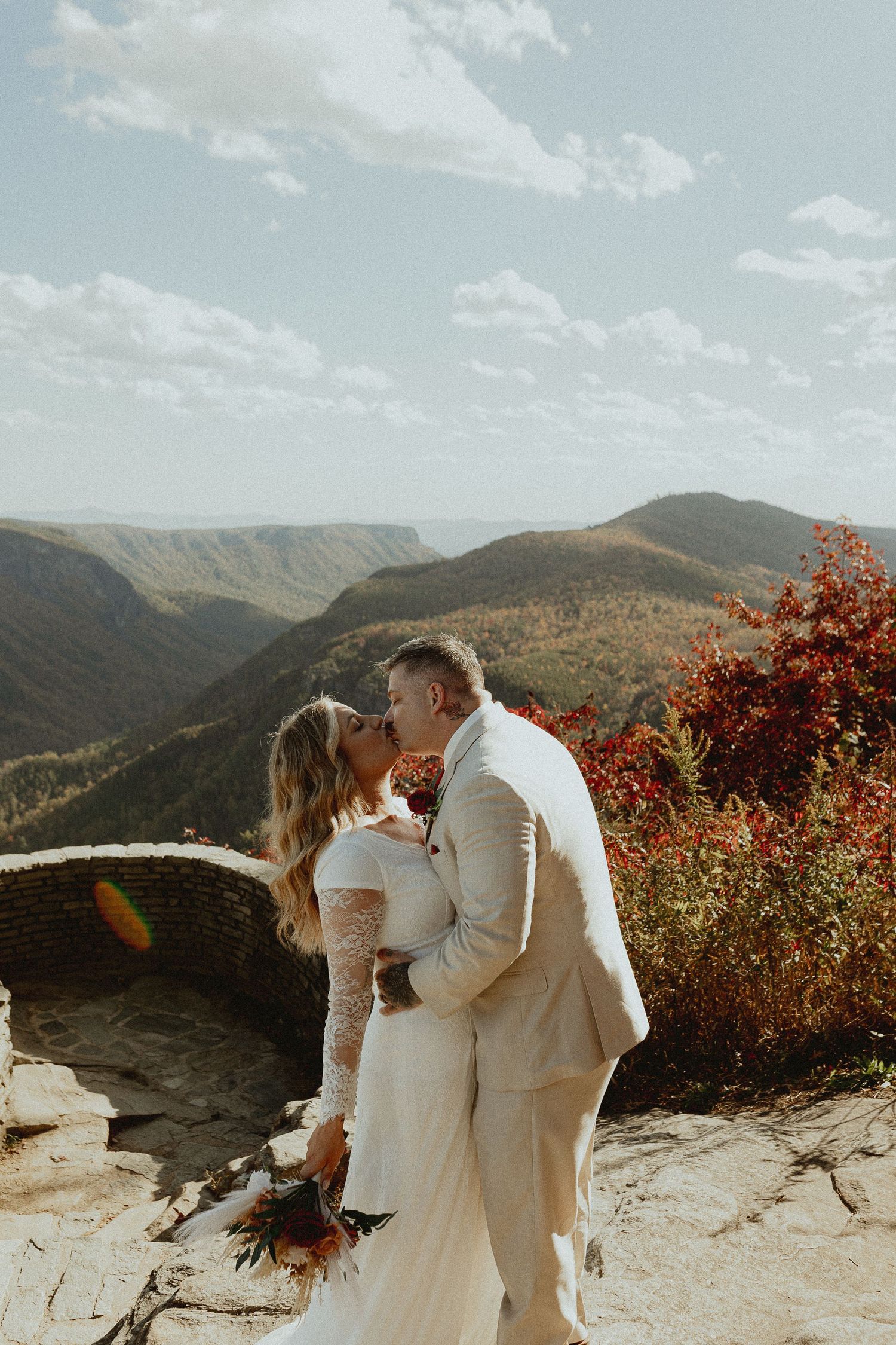 Romantic mountain overlook wedding ceremony with stunning valley views and fall foliage.