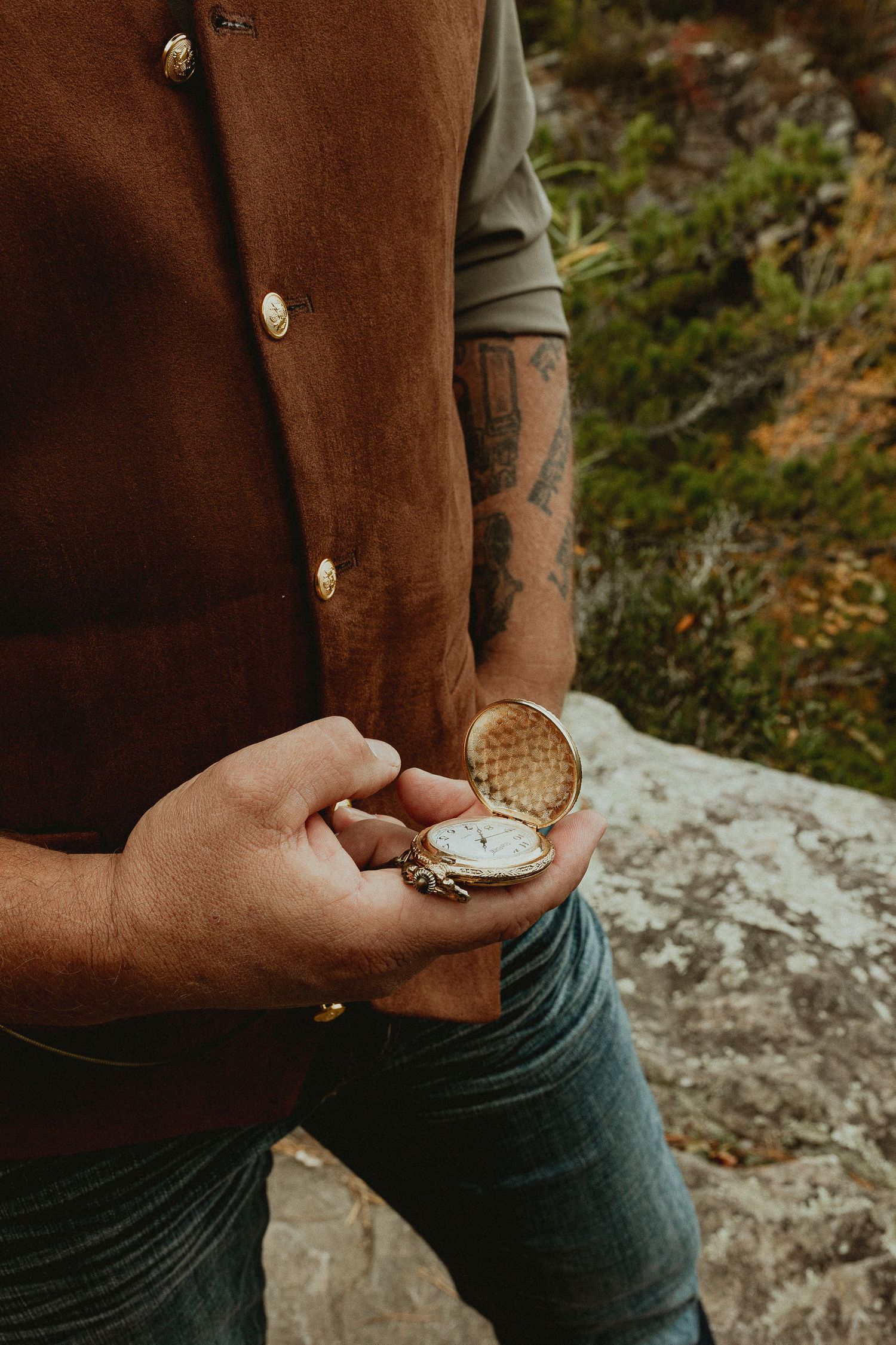 Close-up sequence of hands holding a vintage pocket watch outdoors.