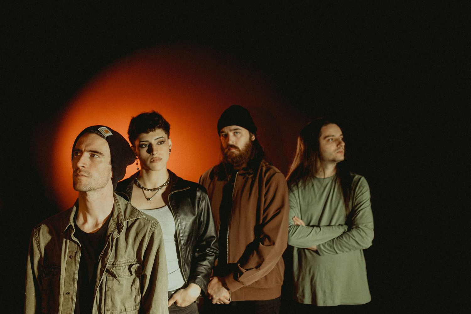 Moody band photo with orange lighting gradient and dark shadows.