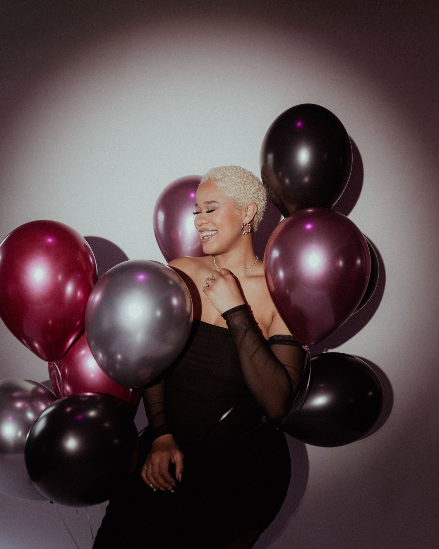 Artistic photo series with burgundy and silver balloons against a dark background.