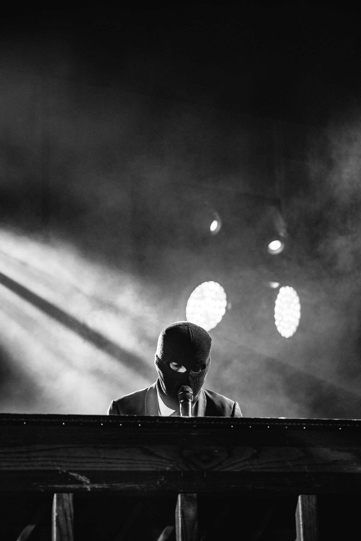 Silhouetted DJ performance with dramatic backlighting and fog effects.