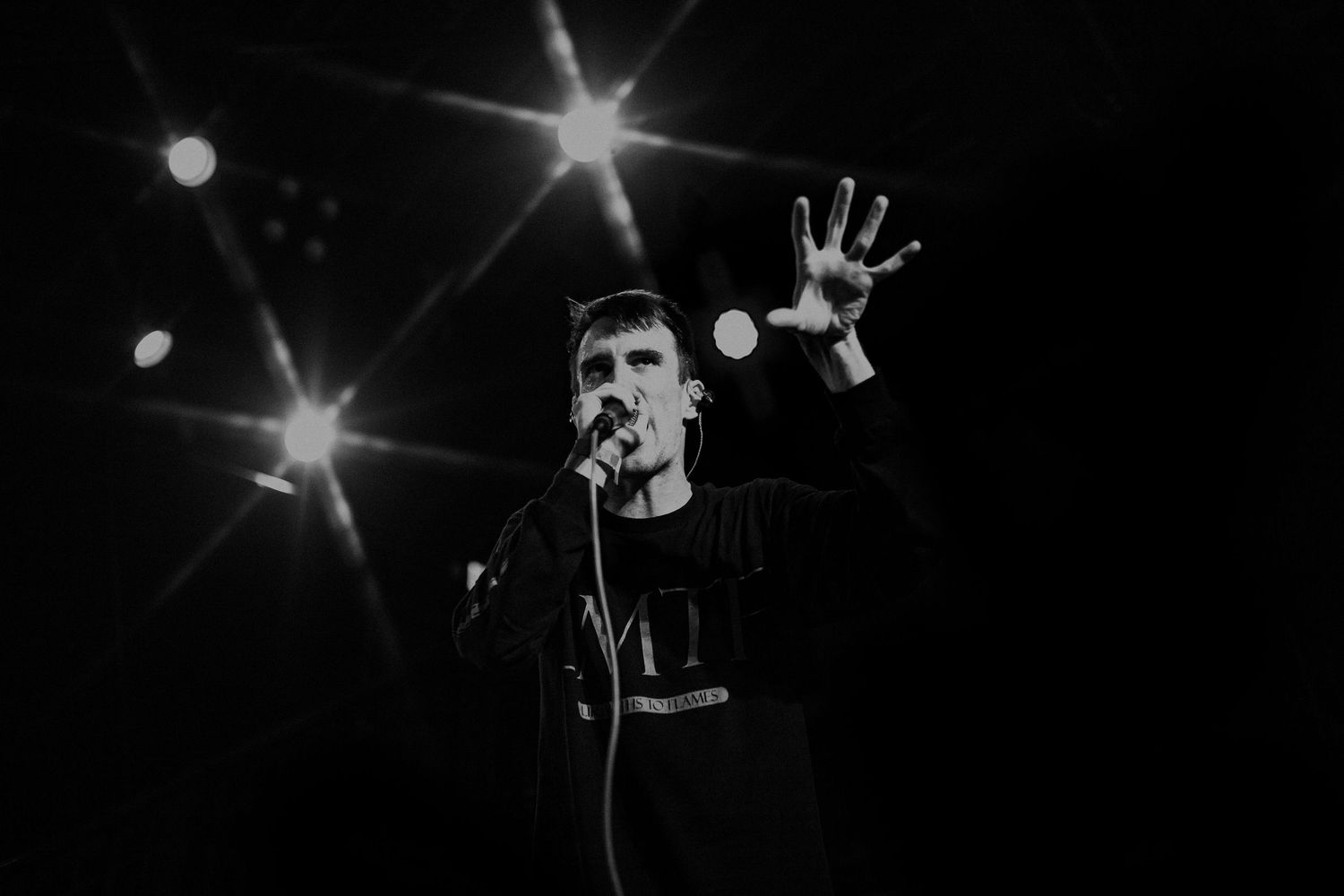 Concert stage illuminated with starburst lighting effects creating a dramatic atmosphere.