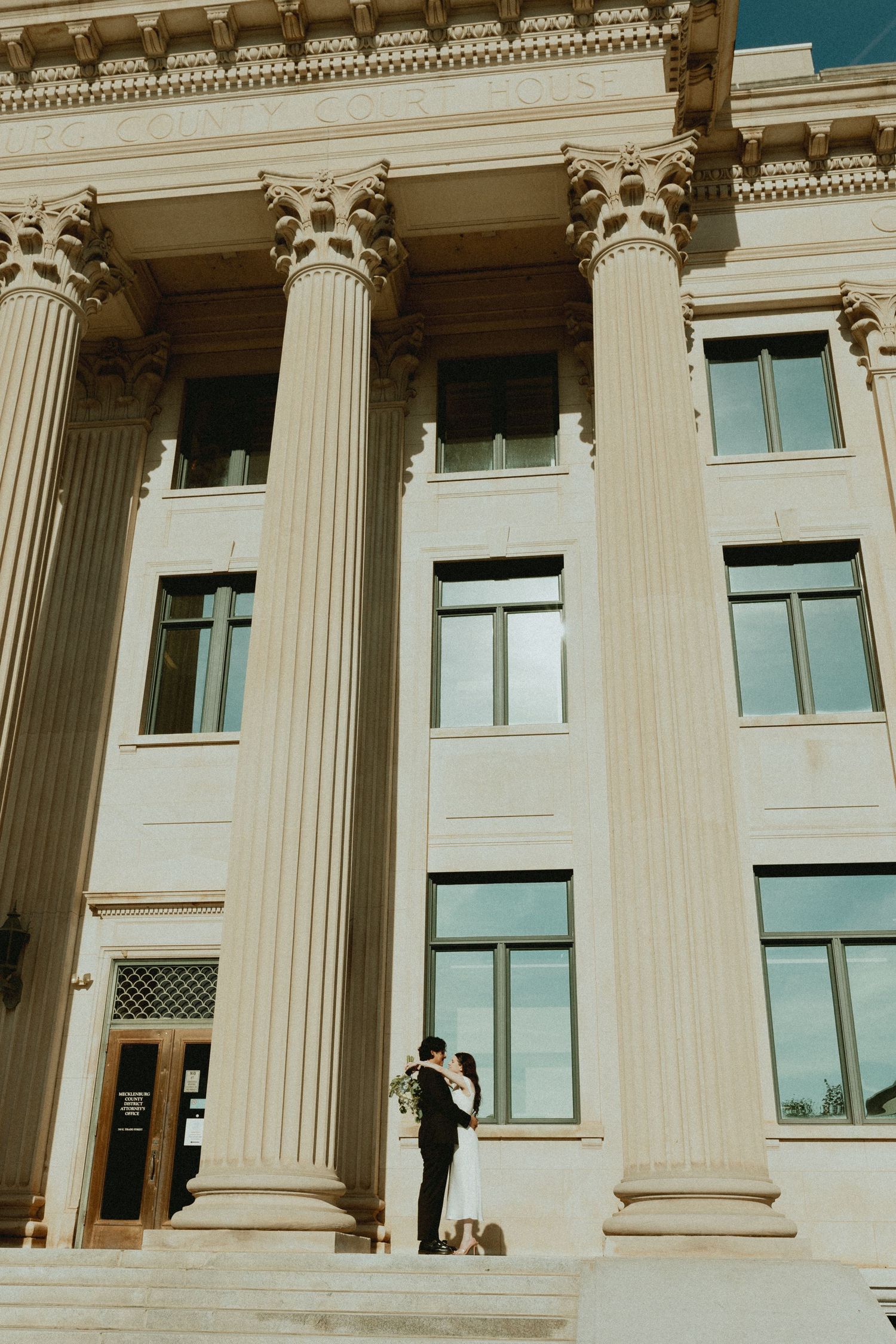 Classical building facade with grand white columns and windows photographed in sequence.