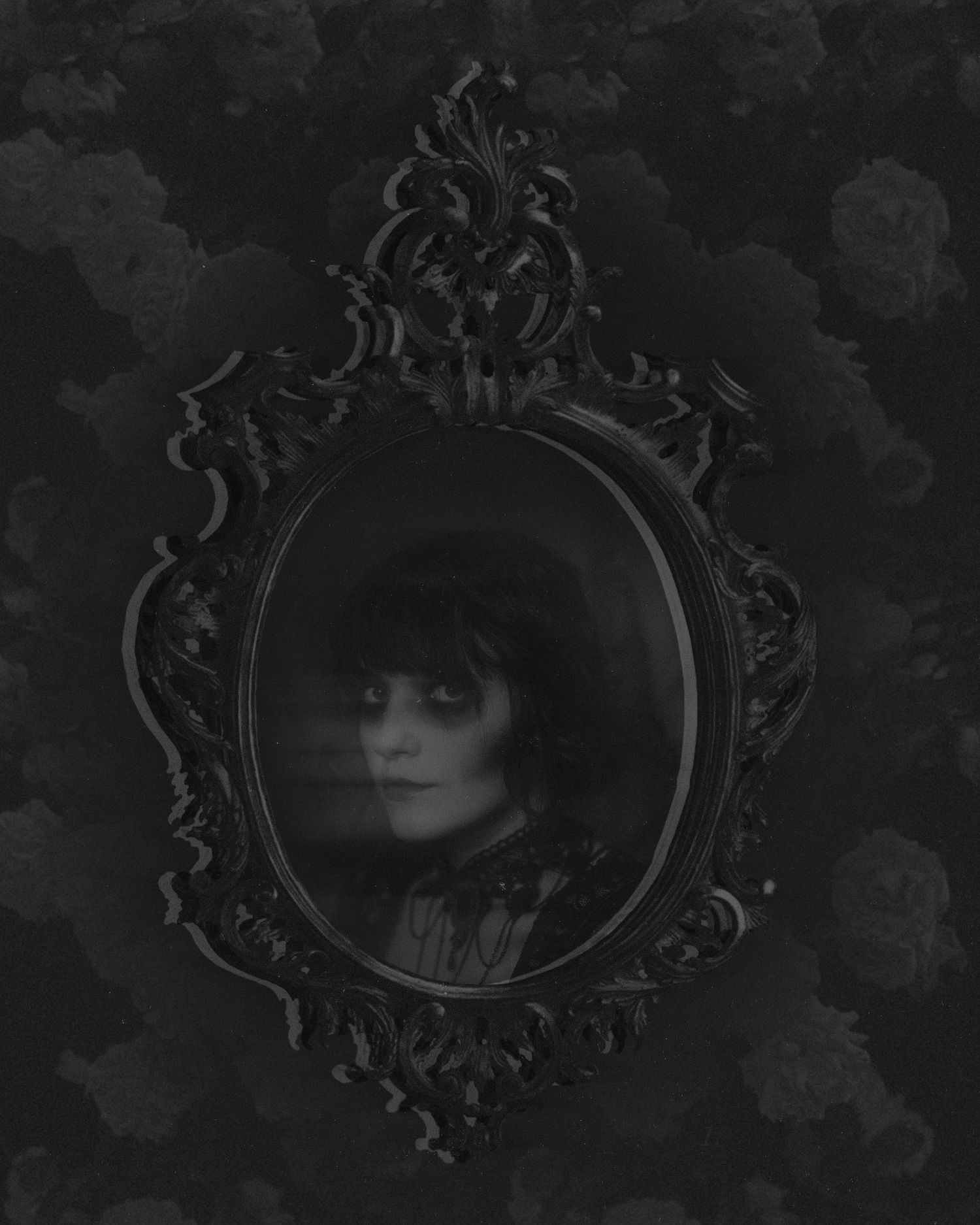 Gothic-inspired black and white portraits in vintage ornate frames against dark floral wallpaper.