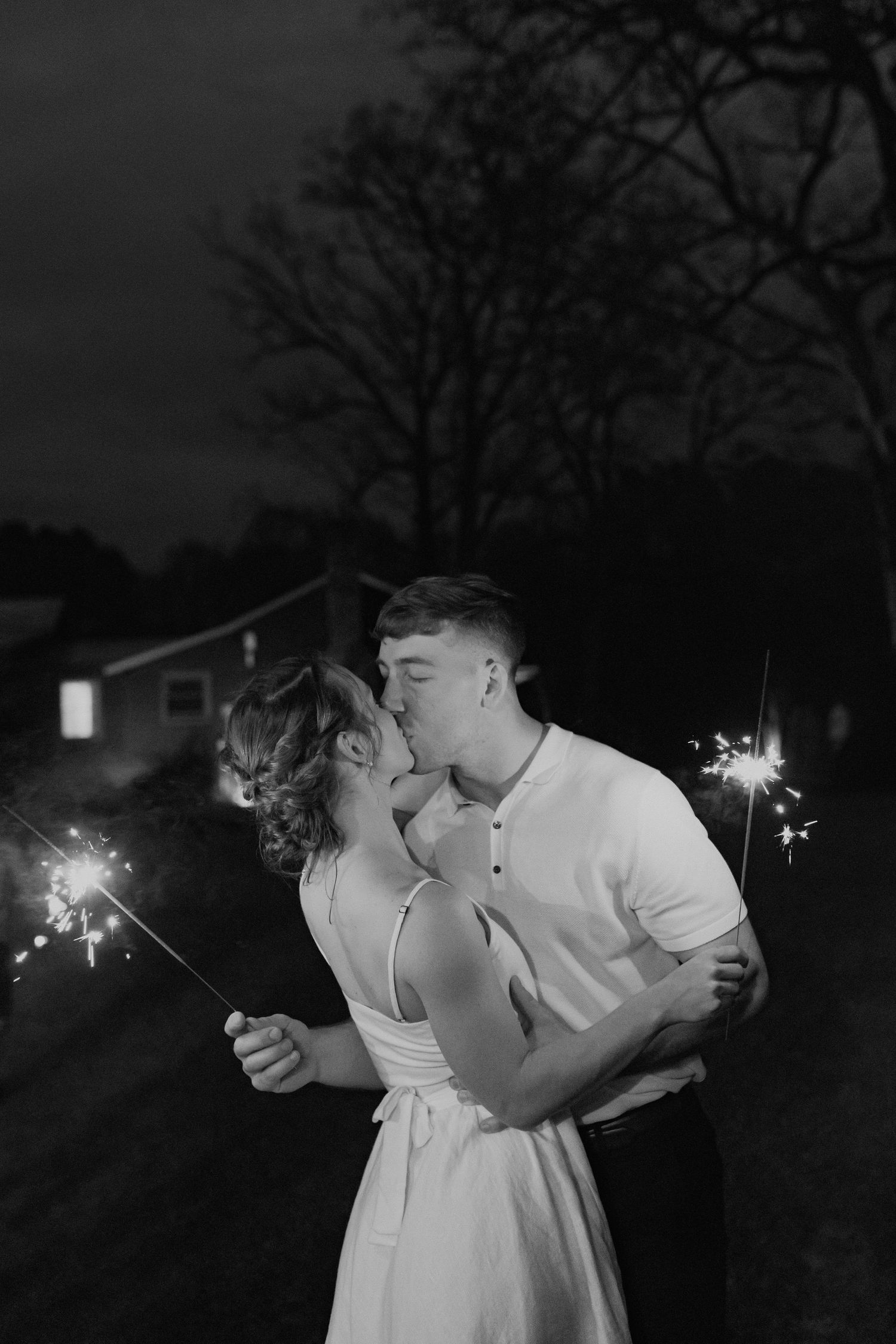 Romantic nighttime portraits with sparklers creating magical wedding moments.