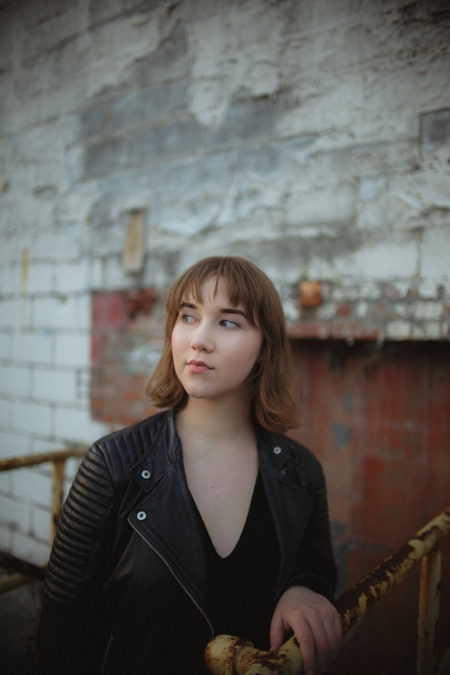 Urban portrait against industrial brick wall background.