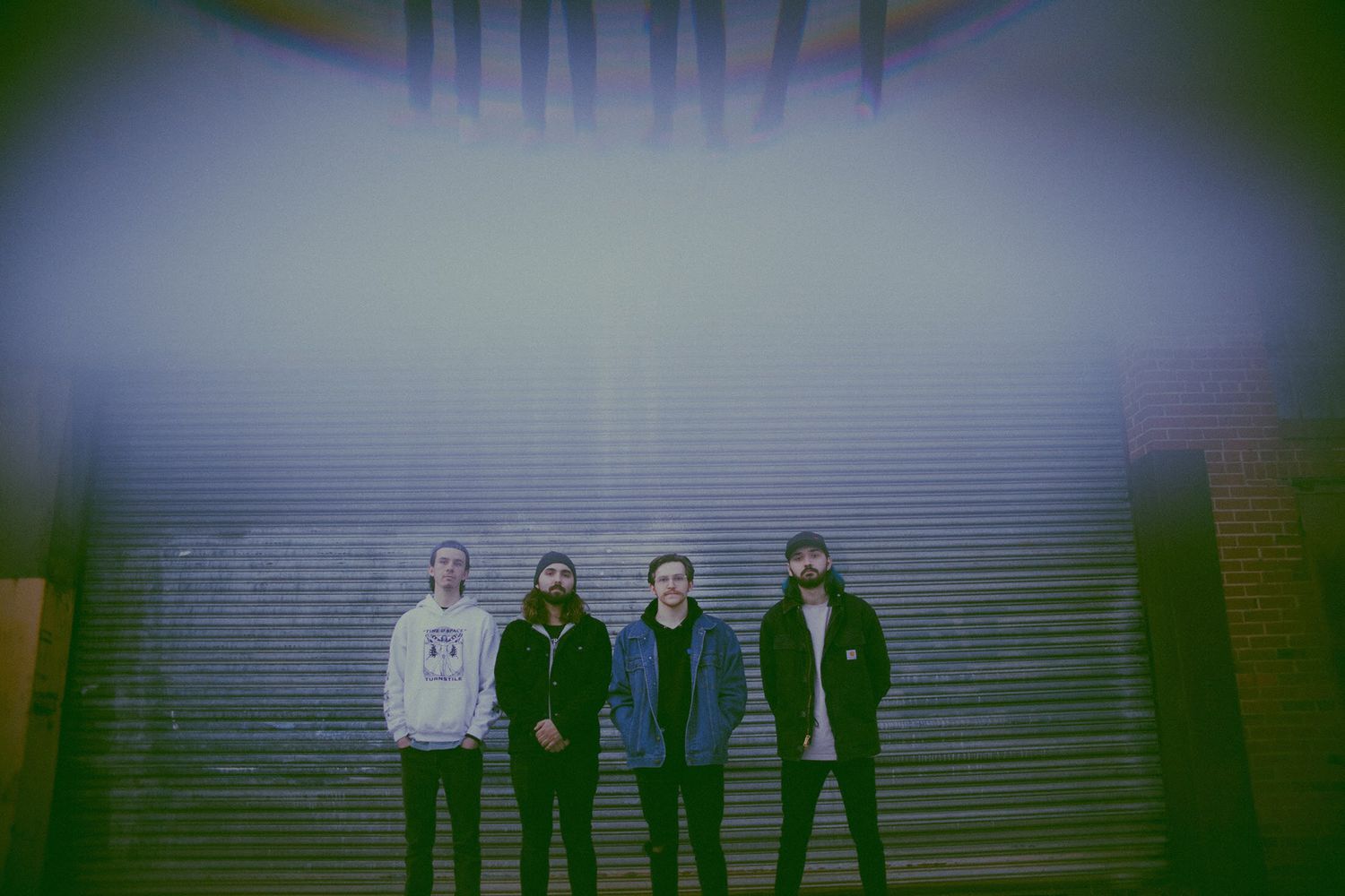 Group photo with dark silhouettes against a blue-tinted background.