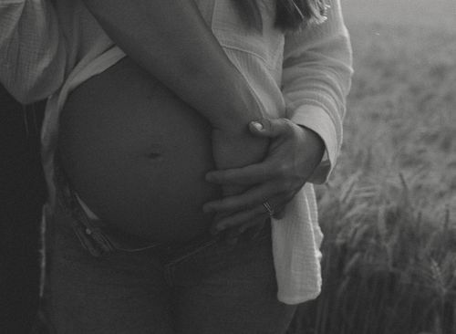 Summer farm maternity lifestyle session in Northern Indiana in wheat fields