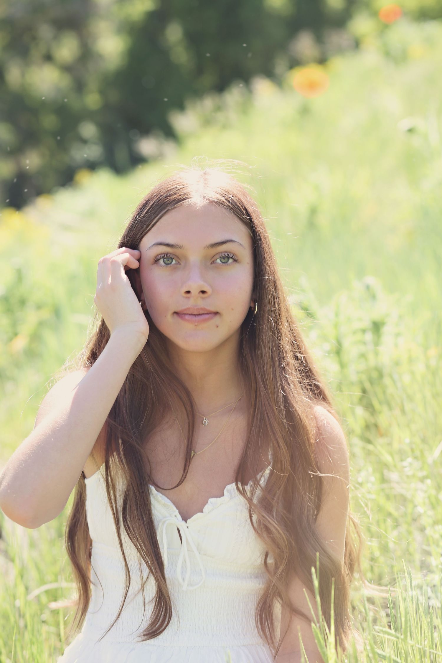 Portrait in a summer meadow with soft natural lighting and wildflowers.