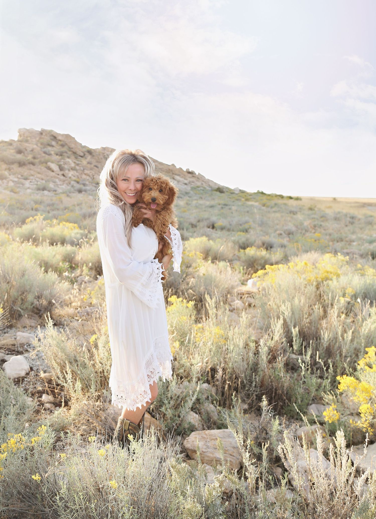 Ethereal white dress photographed in desert setting with sagebrush and mountains.