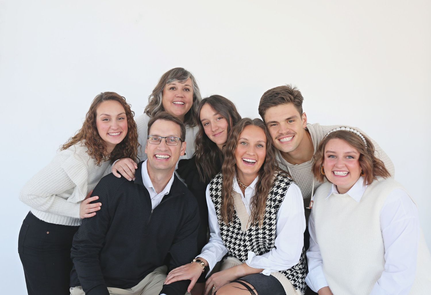 Group photo of people in casual attire against white background.