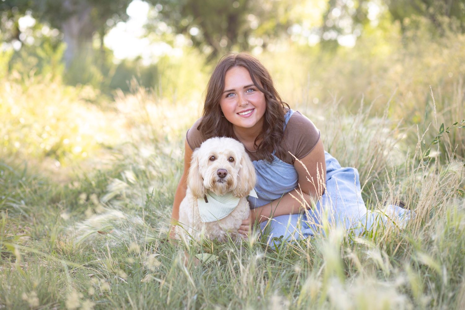 A couple and their dog share joyful moments during a golden hour photoshoot.