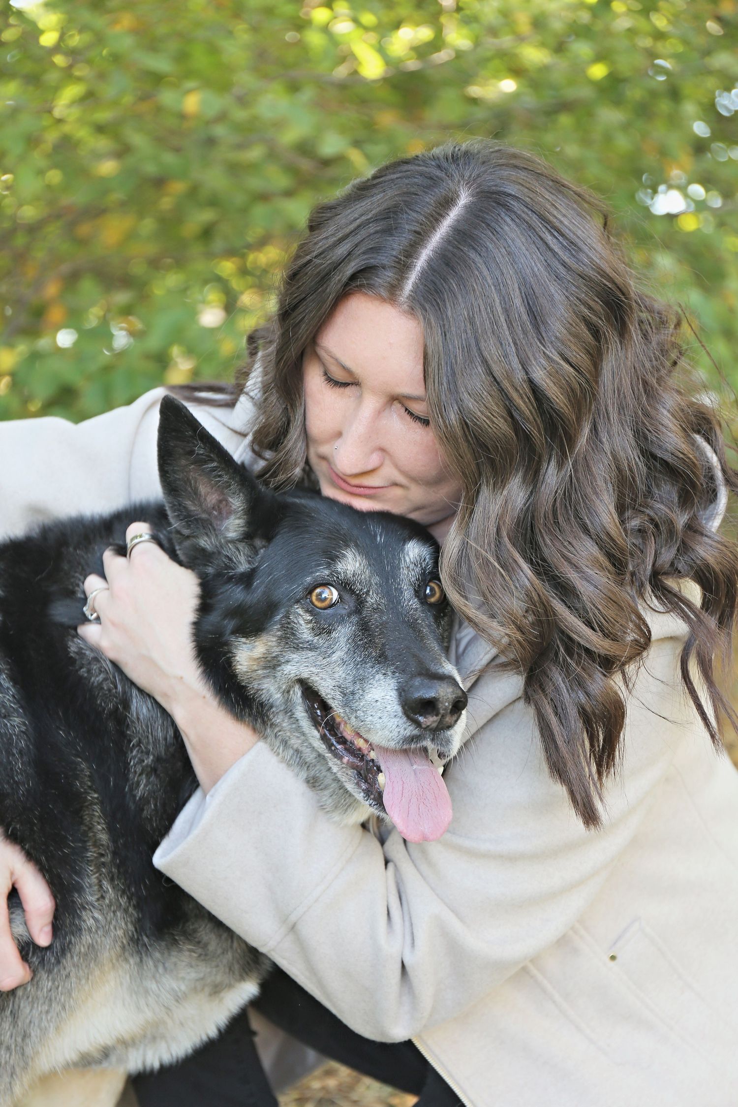 Sweet moments of affection between a dog and its companion in a natural outdoor setting.