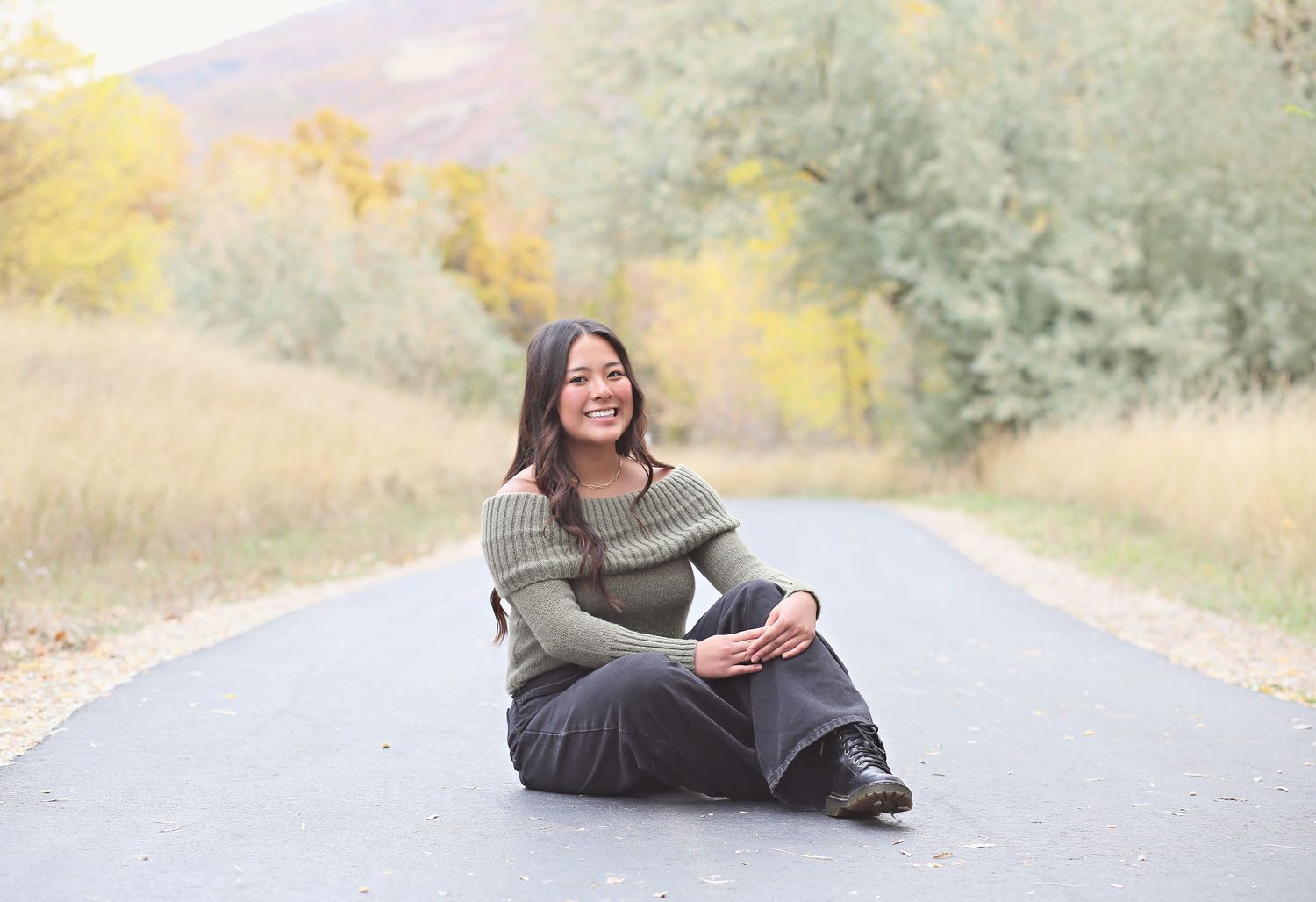 Outdoor portrait session on a rural road during golden hour.