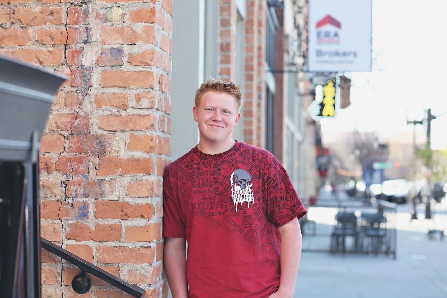 Urban portraits against rustic brick wall in downtown setting.