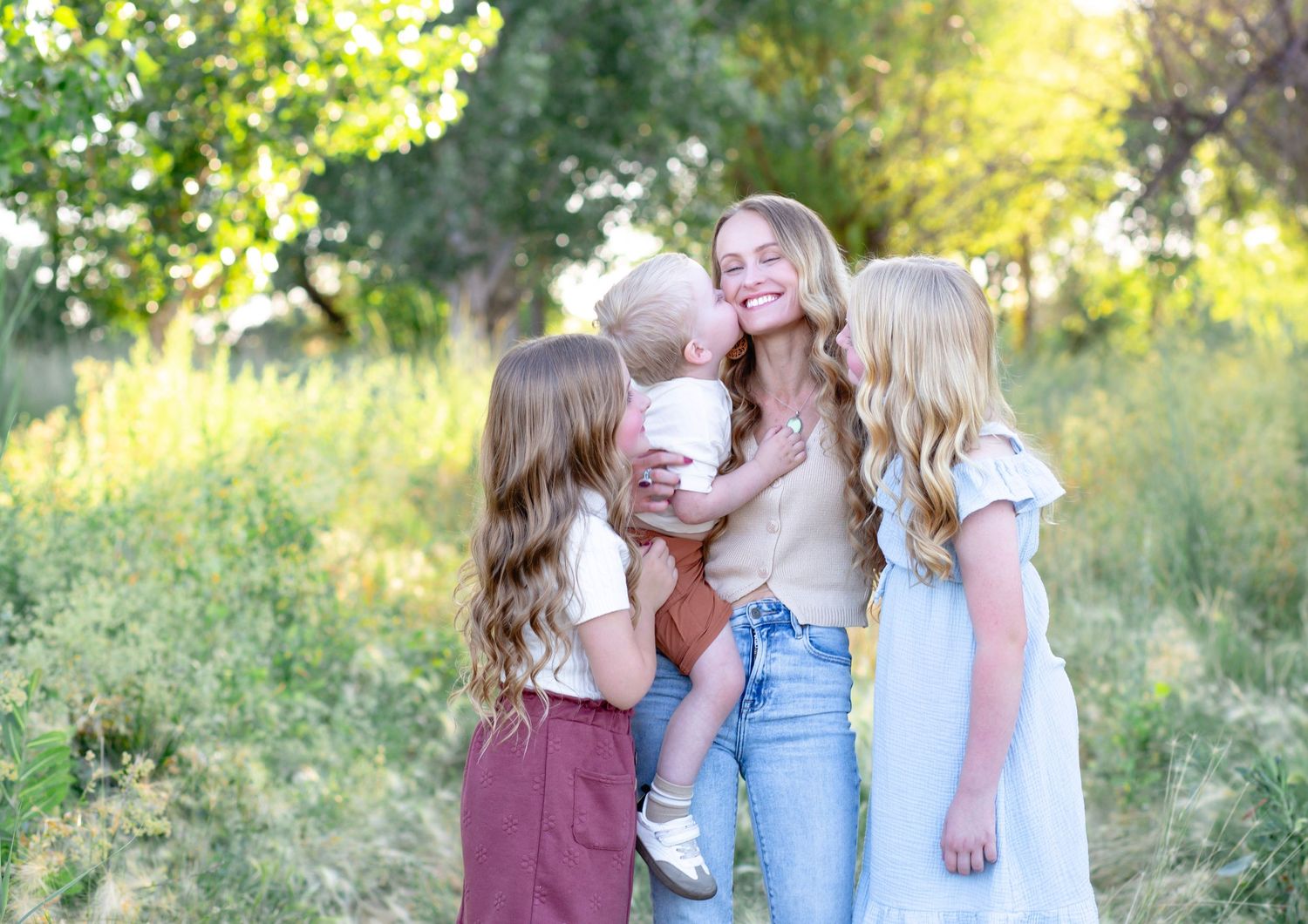 Group photo session in sunny outdoor field with natural lighting.