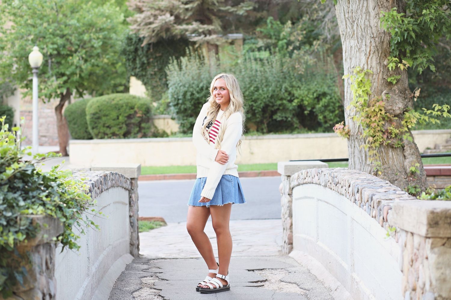 Casual summer outfit photographed on a decorative stone bridge pathway.