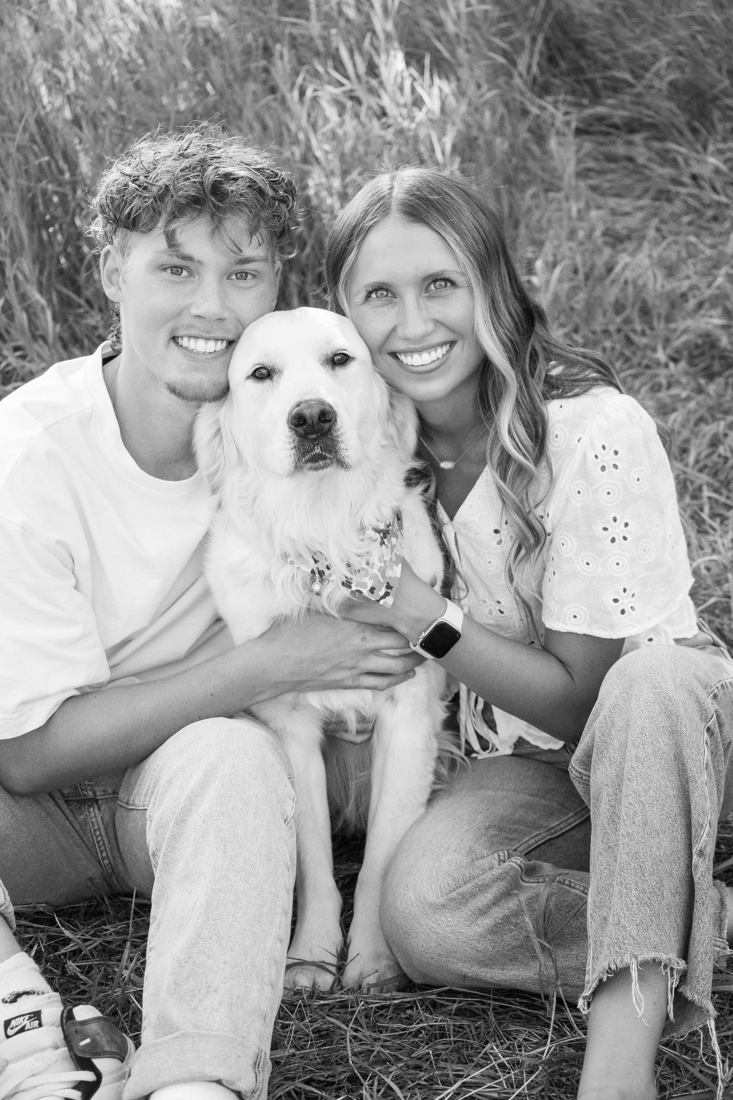 Casual outdoor photoshoot with white dog in grassy setting during summer.