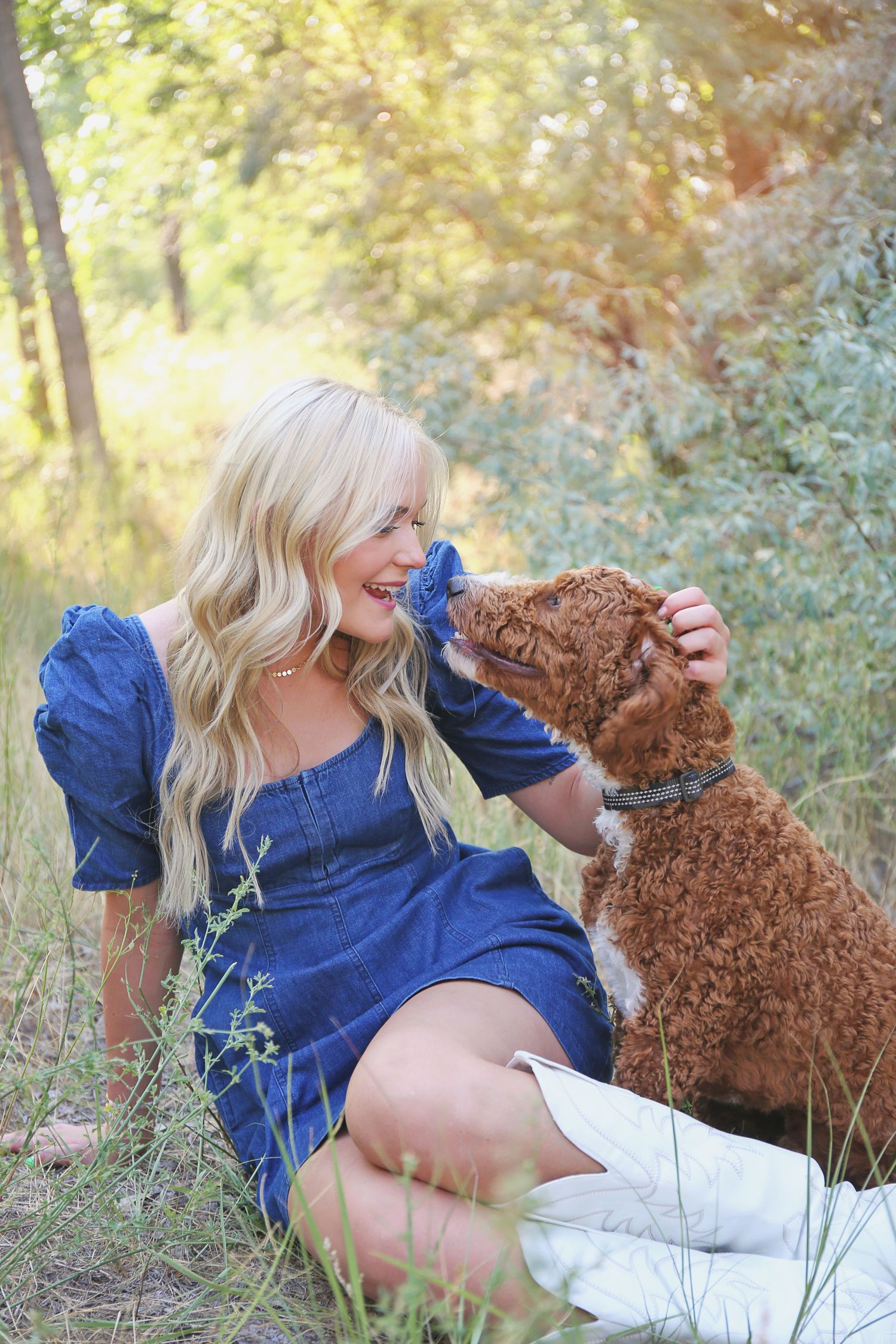 Playful outdoor portrait with brown teddy bear in blue dress.