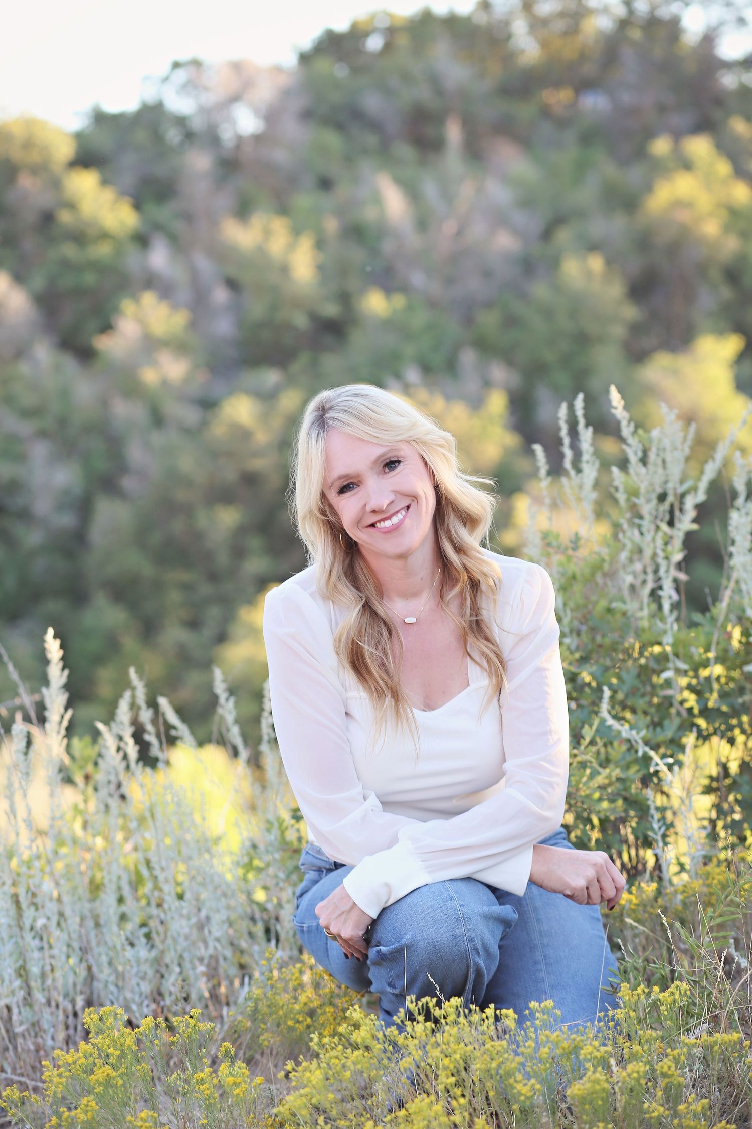 A casual outdoor portrait among yellow wildflowers and sage brush.
