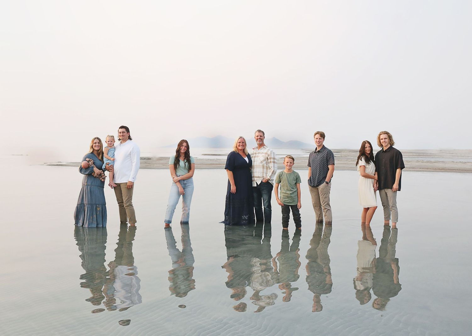 A series of beach photos showing people's reflections in shallow water at sunset.