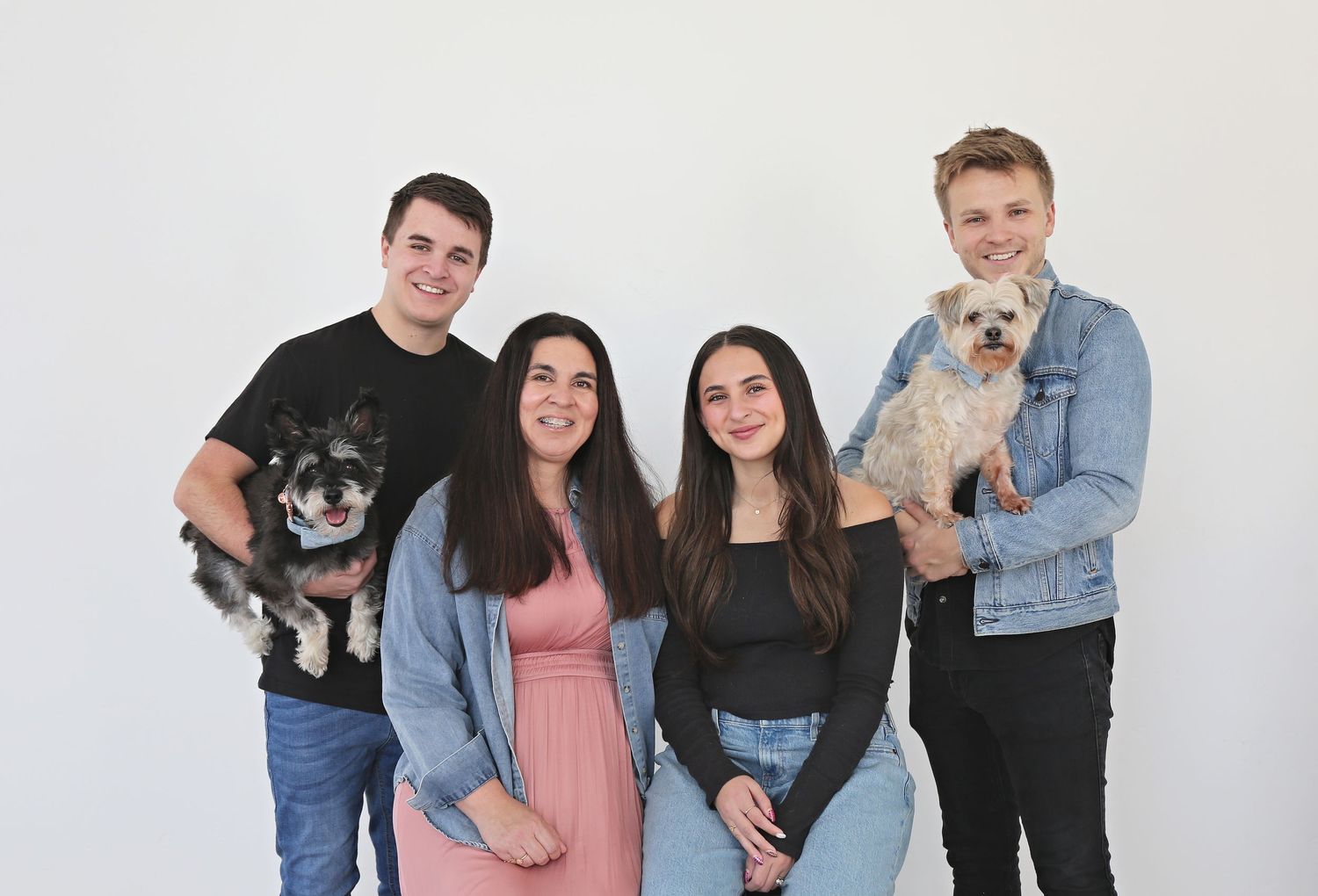 Studio portrait session with white background featuring casual group poses.