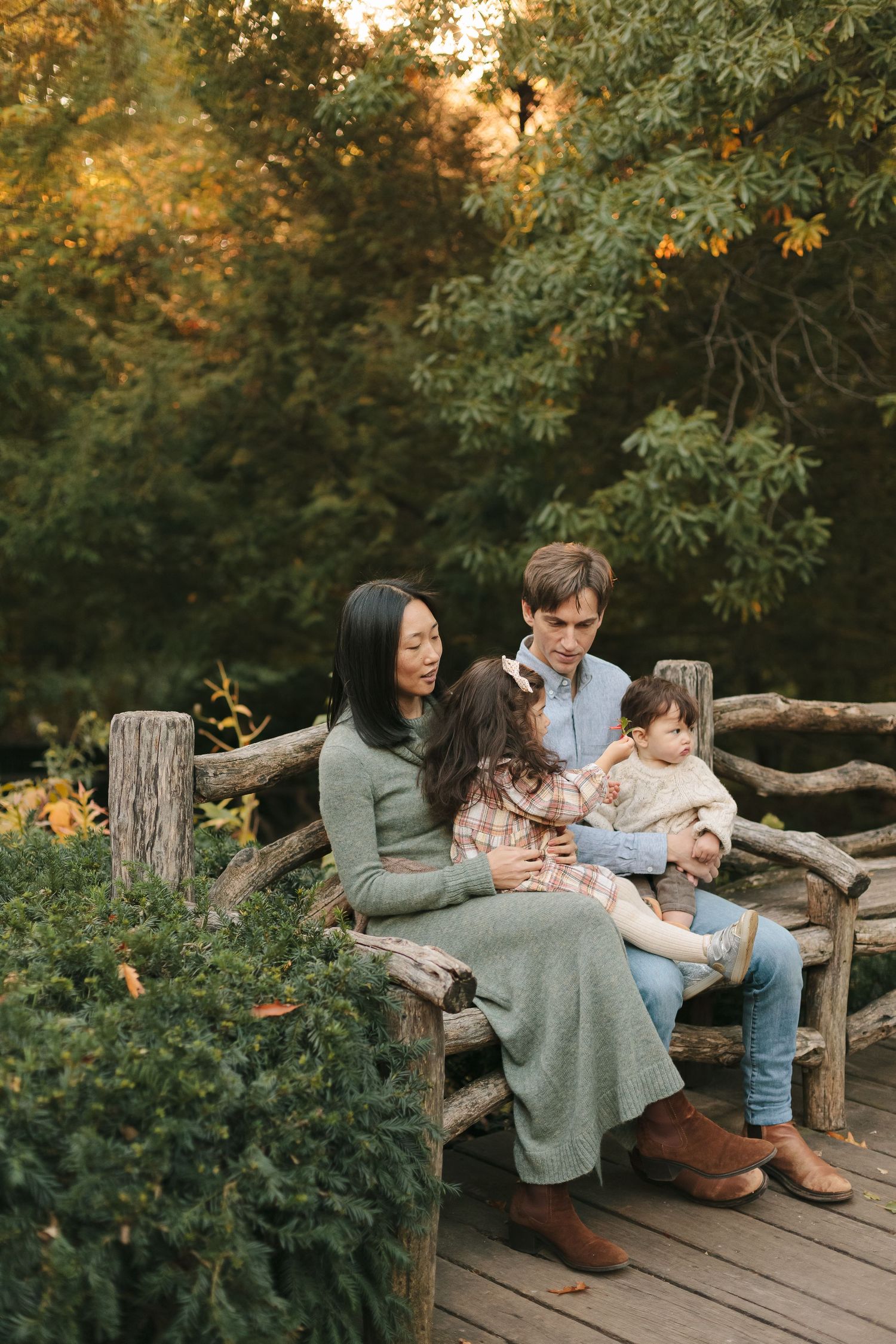 Candid family moment at Central Park during golden hour, photo by Paula Brearley NYC family photographer