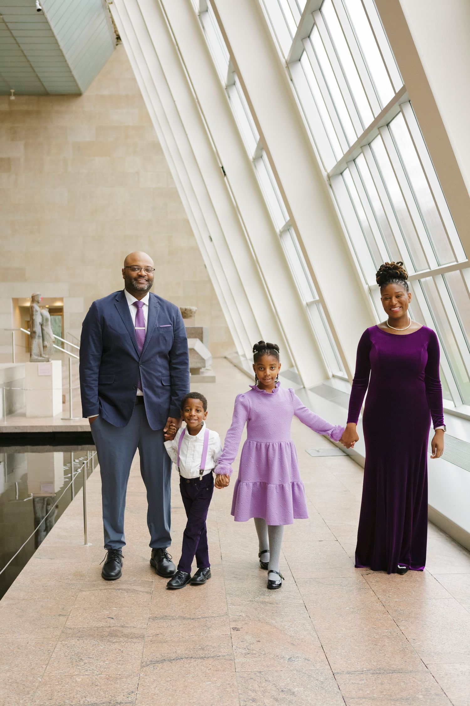 Happy family smiling during a session at the Metropolitan Museum of art, by Paula Brearley NYC family photographer