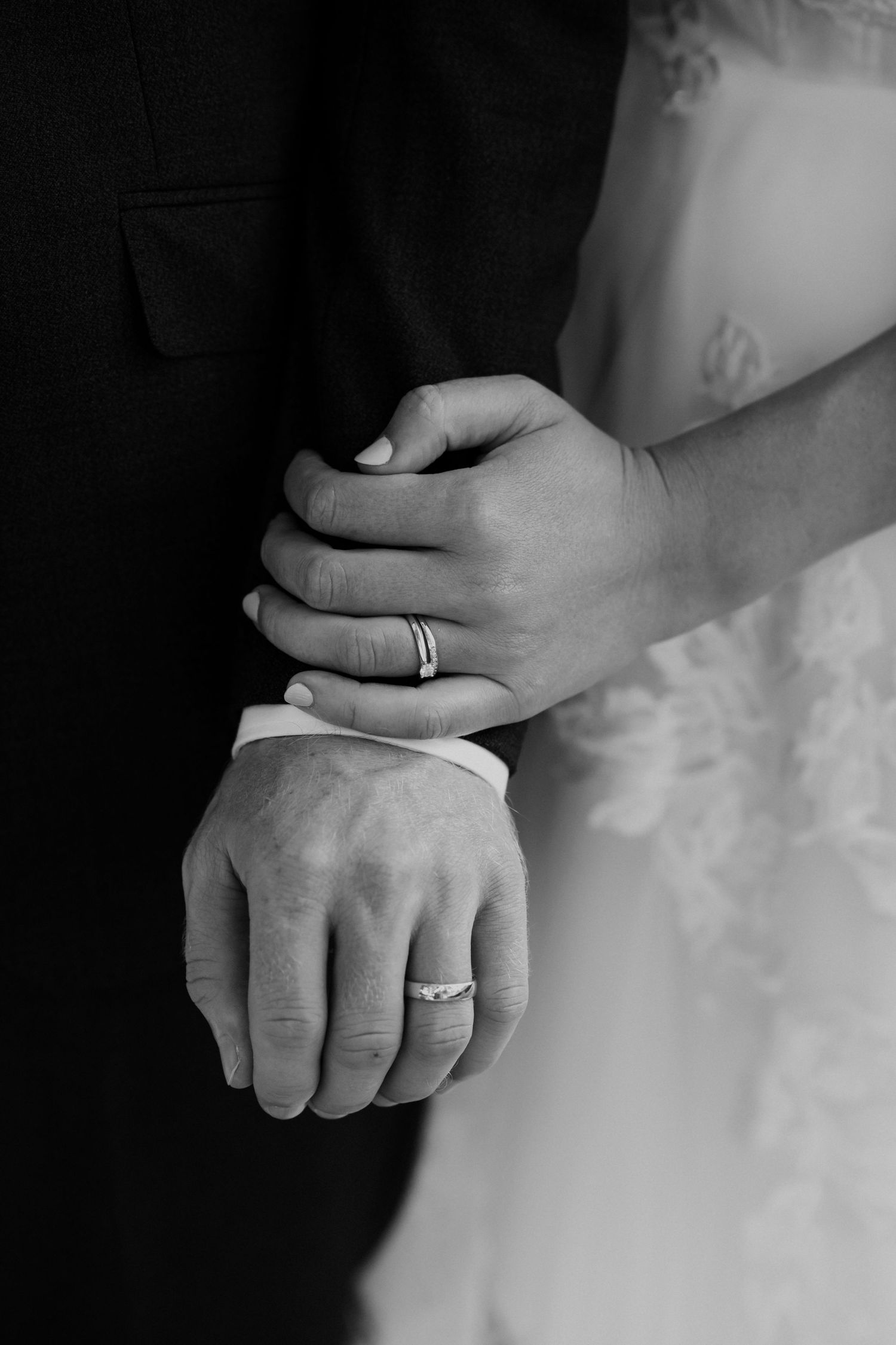 Close-up series showing wedding rings and hands in black and white photography creating an artistic composition by August and Vine