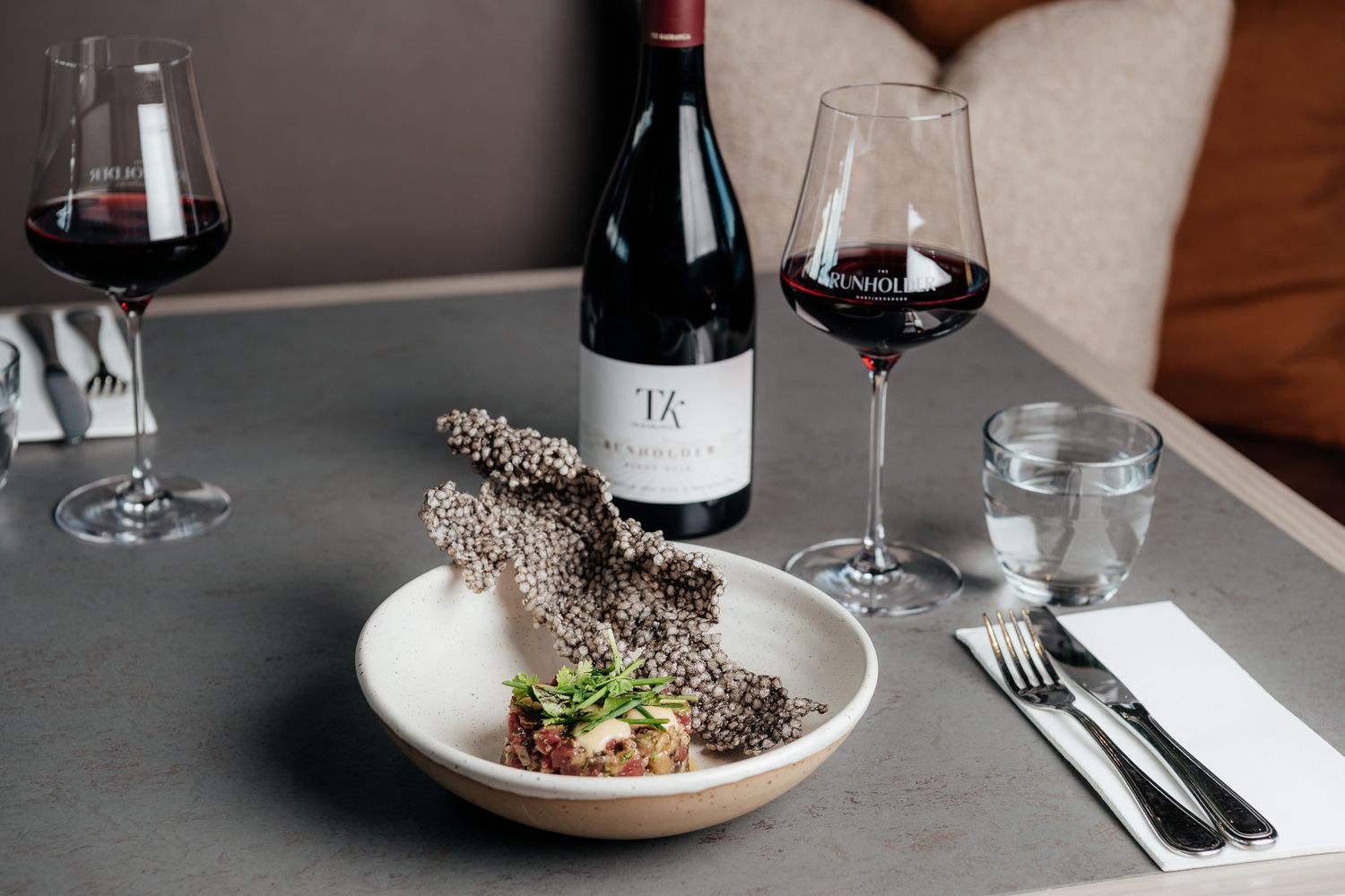 Wine and elegant plated dishes create an upscale dining atmosphere at the Runholder by August and Vine