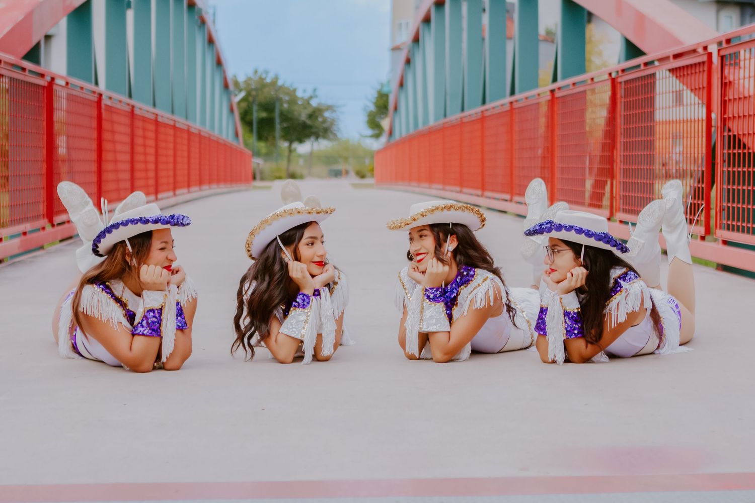 four dancers smiling at each other