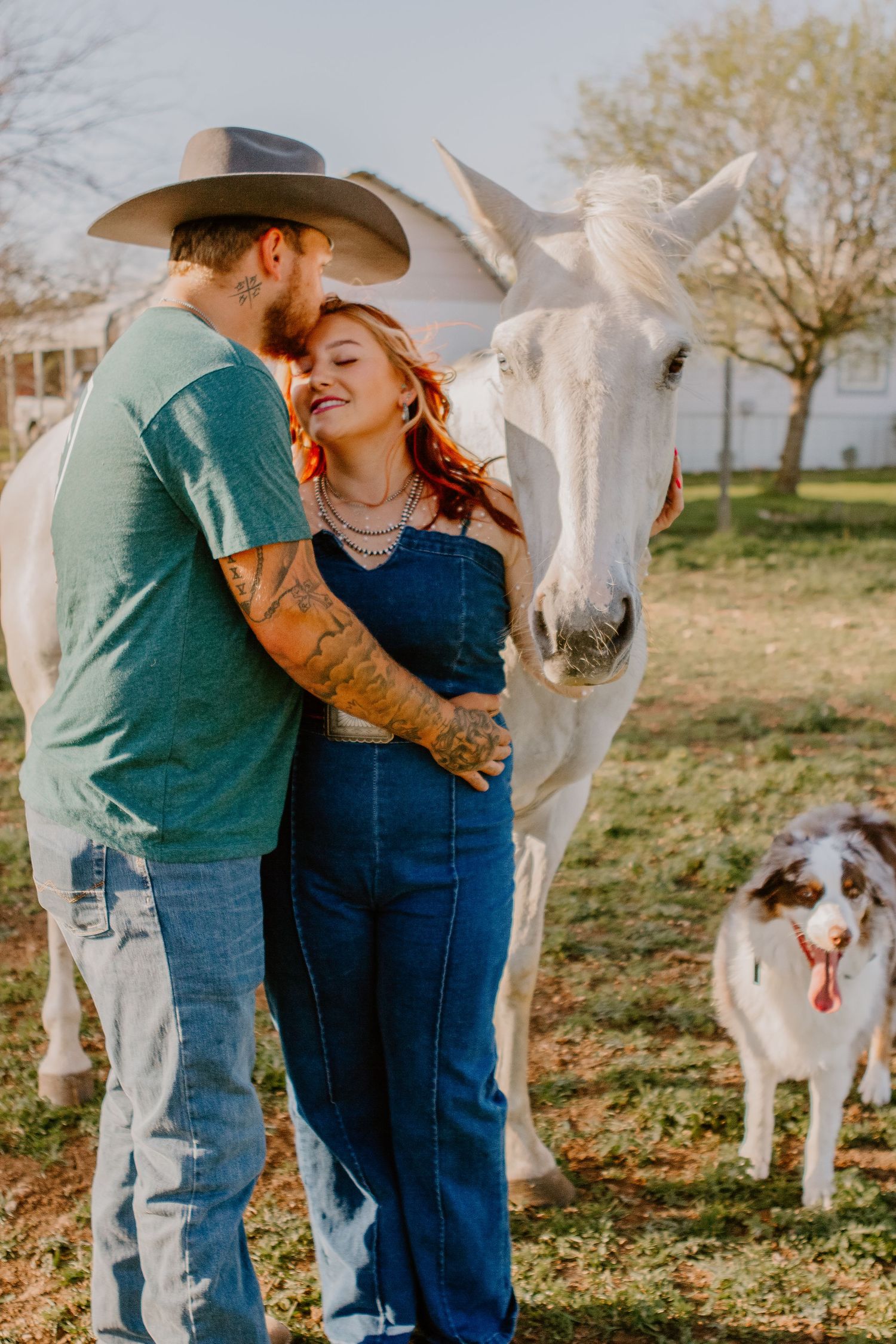 couple with their horse and dog