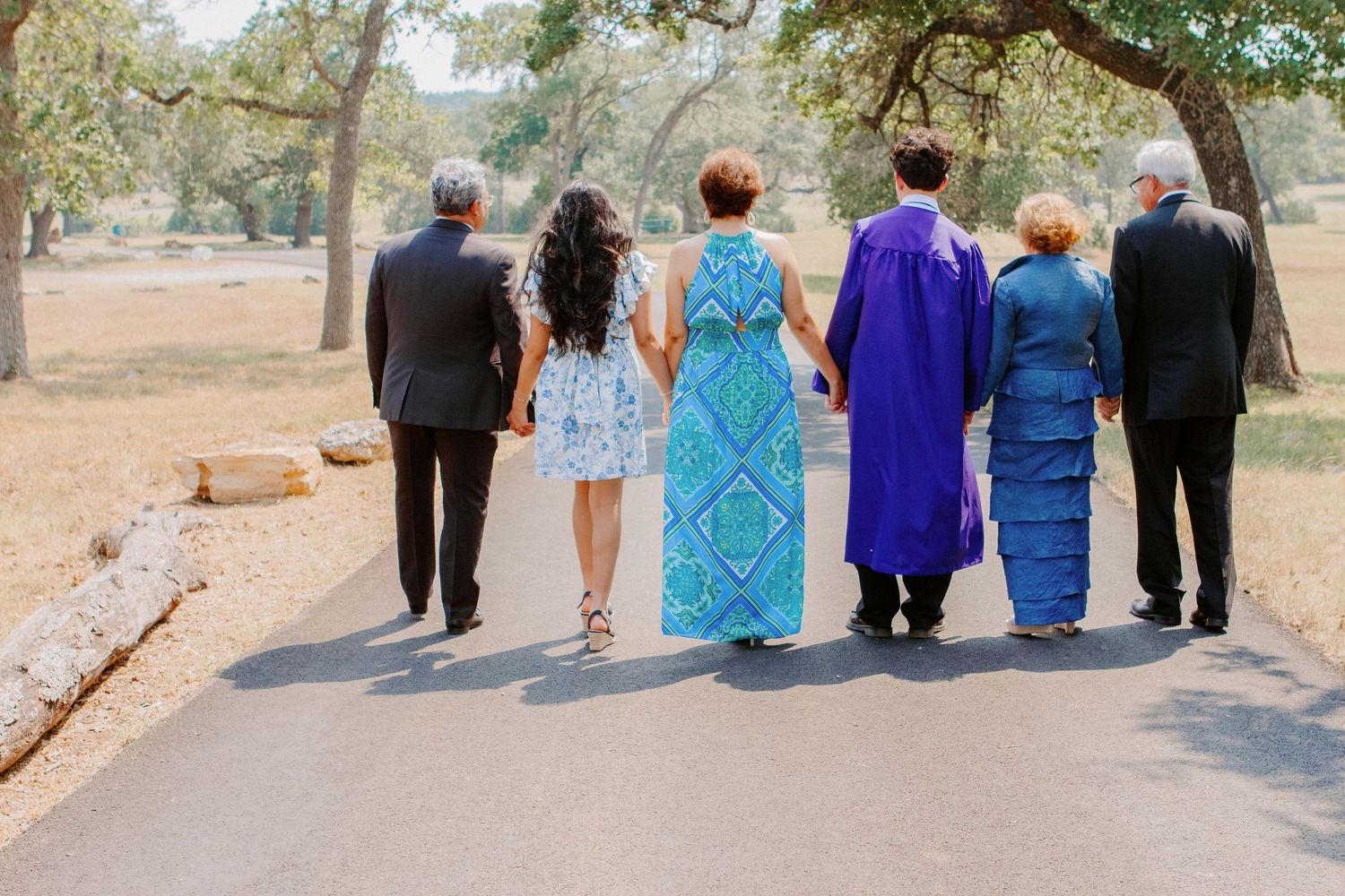 family holding hands walking away
