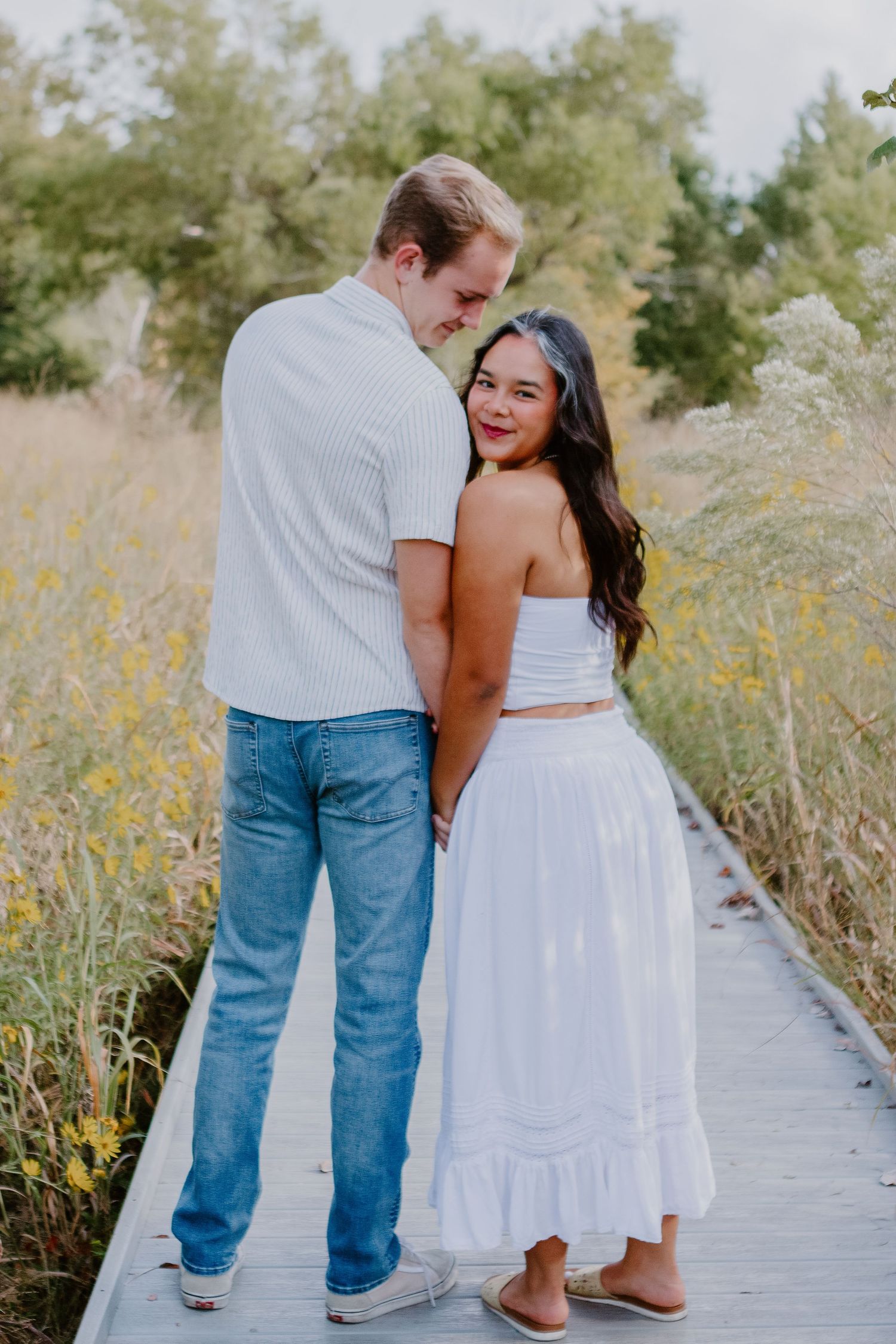 couple with guy looking at girl and girl looking at camera