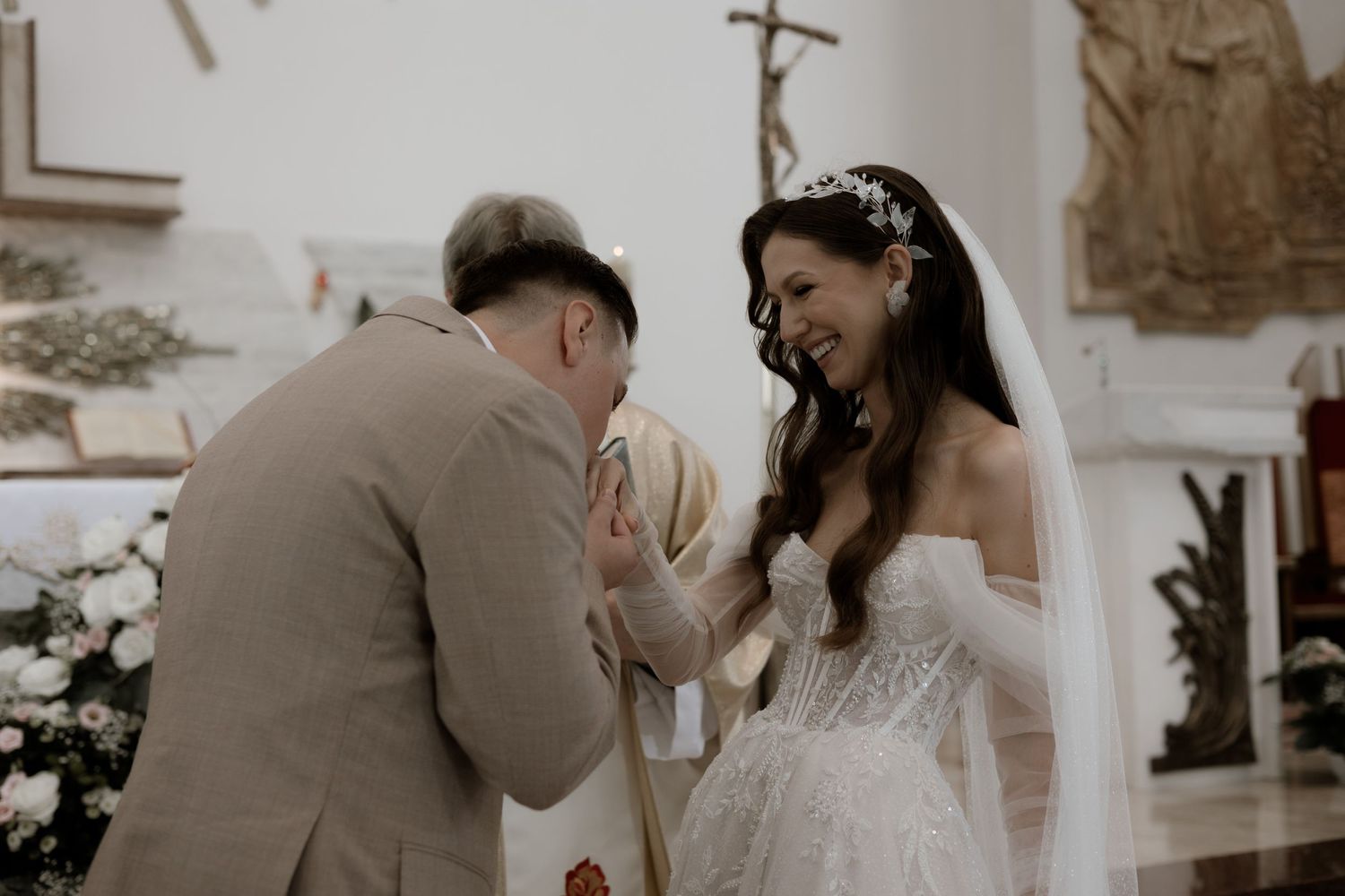 A touching moment captured during a wedding ceremony as newlyweds share an emotional exchange at the altar.