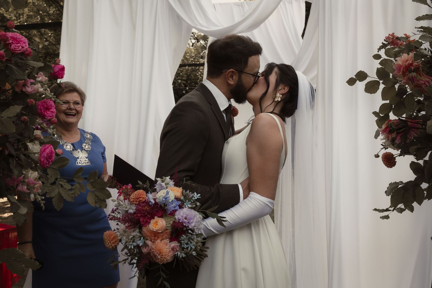 A series of romantic wedding photos showing couples embracing during their ceremony with floral decorations and white curtains.