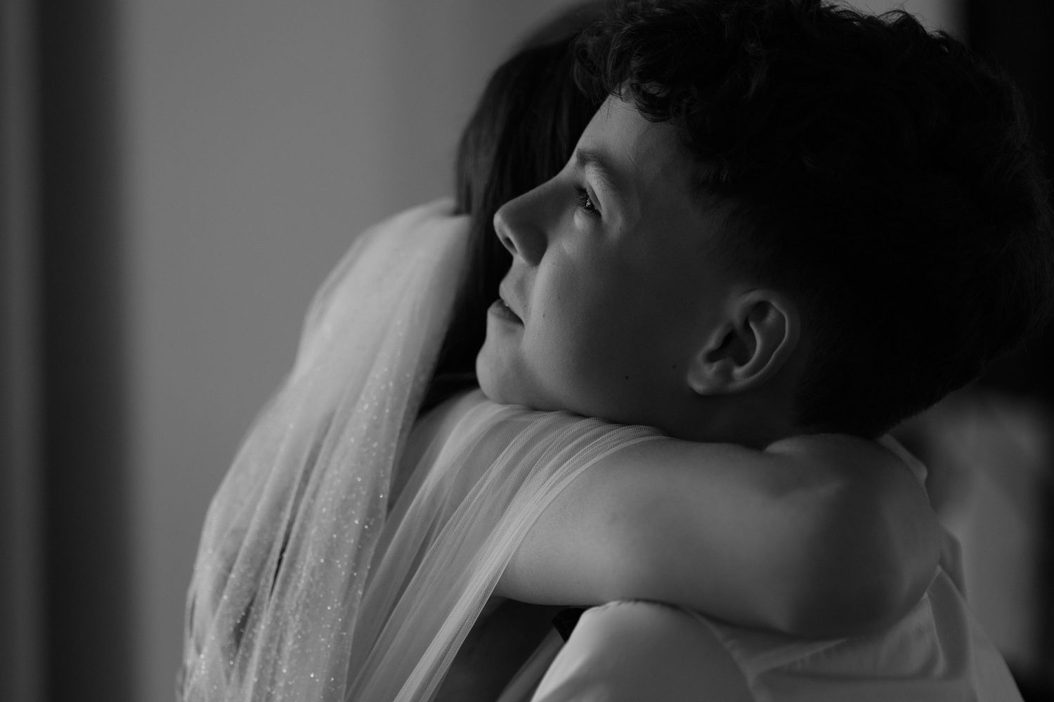 Black and white artistic portrait featuring close up profile view with head tilted back in contemplative pose.