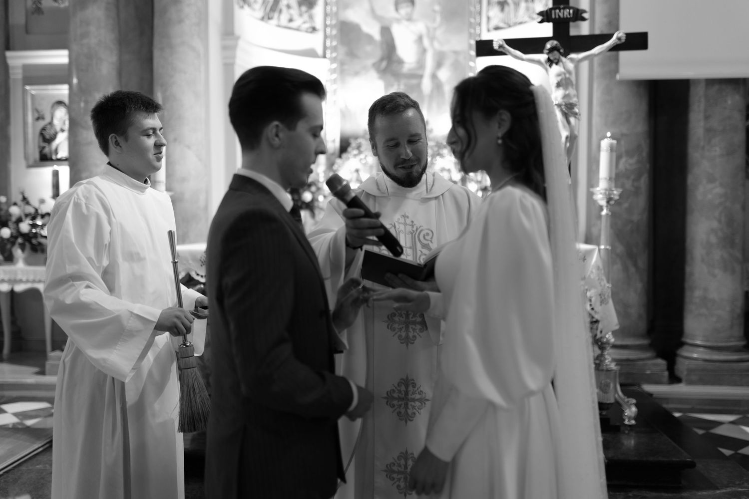 A traditional Catholic wedding ceremony taking place at a church altar with clergy and attendants present.