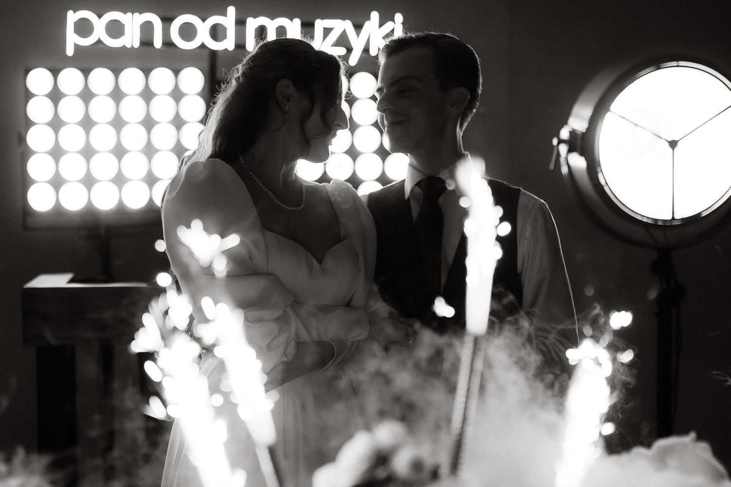 Dramatic nighttime photo with smoke effects and stage lighting creating atmospheric ambiance.