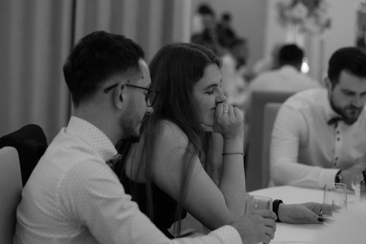 Black and white photo of people seated at a table during what appears to be a formal dinner or event.