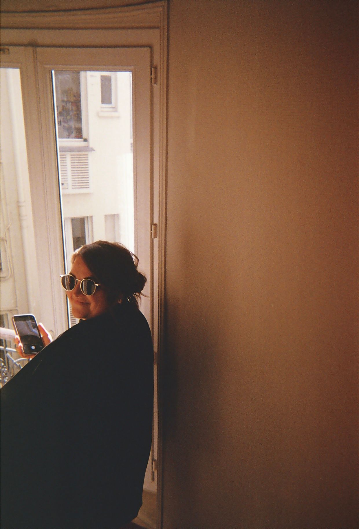 Artistic silhouette portrait by window with warm natural lighting.