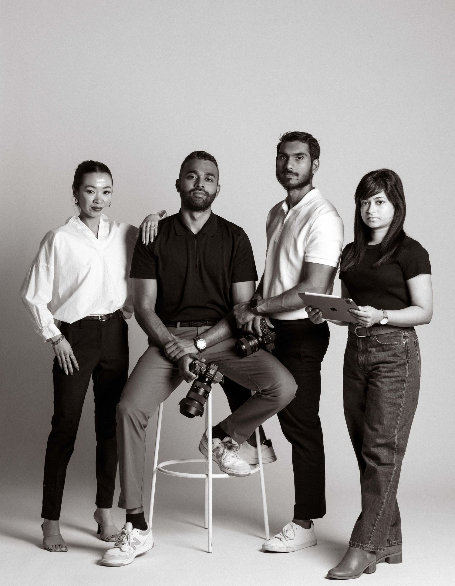 A black and white photo series showing people seated on chairs in various casual poses against a white backdrop.