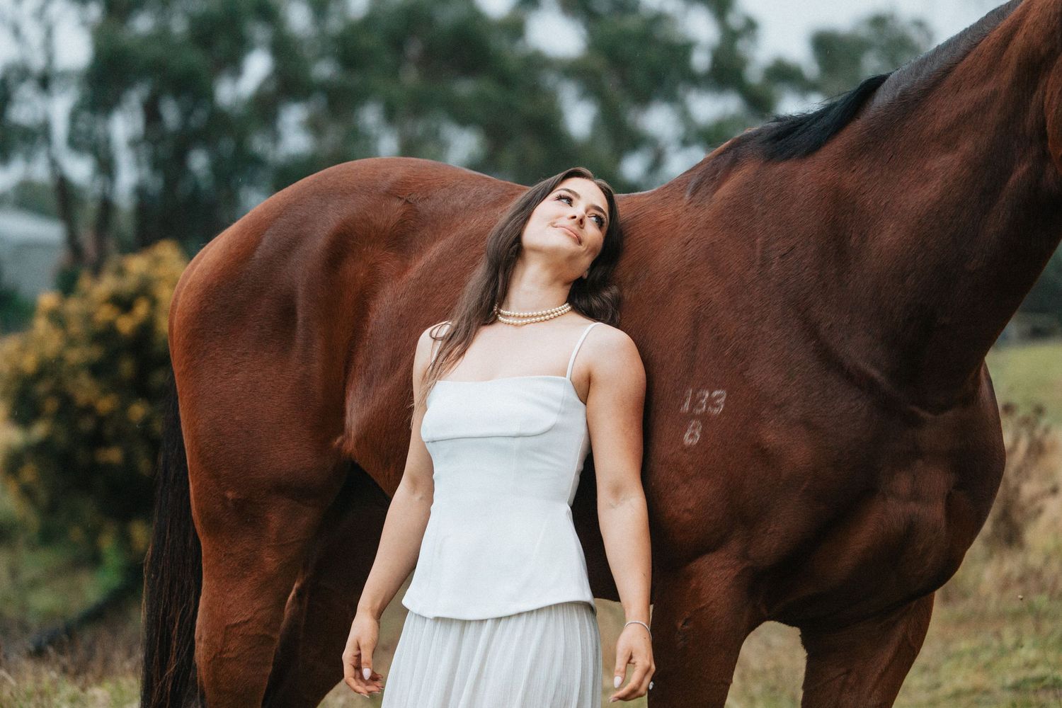 Elegant bride in her gown with her horse, a moment together