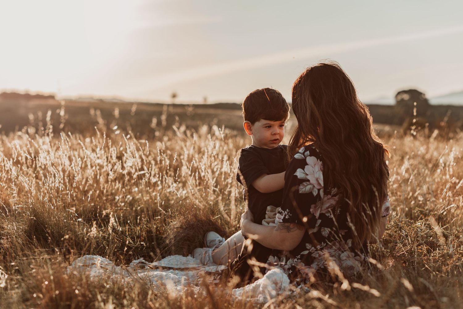 mum and son in a sunset filled pasture