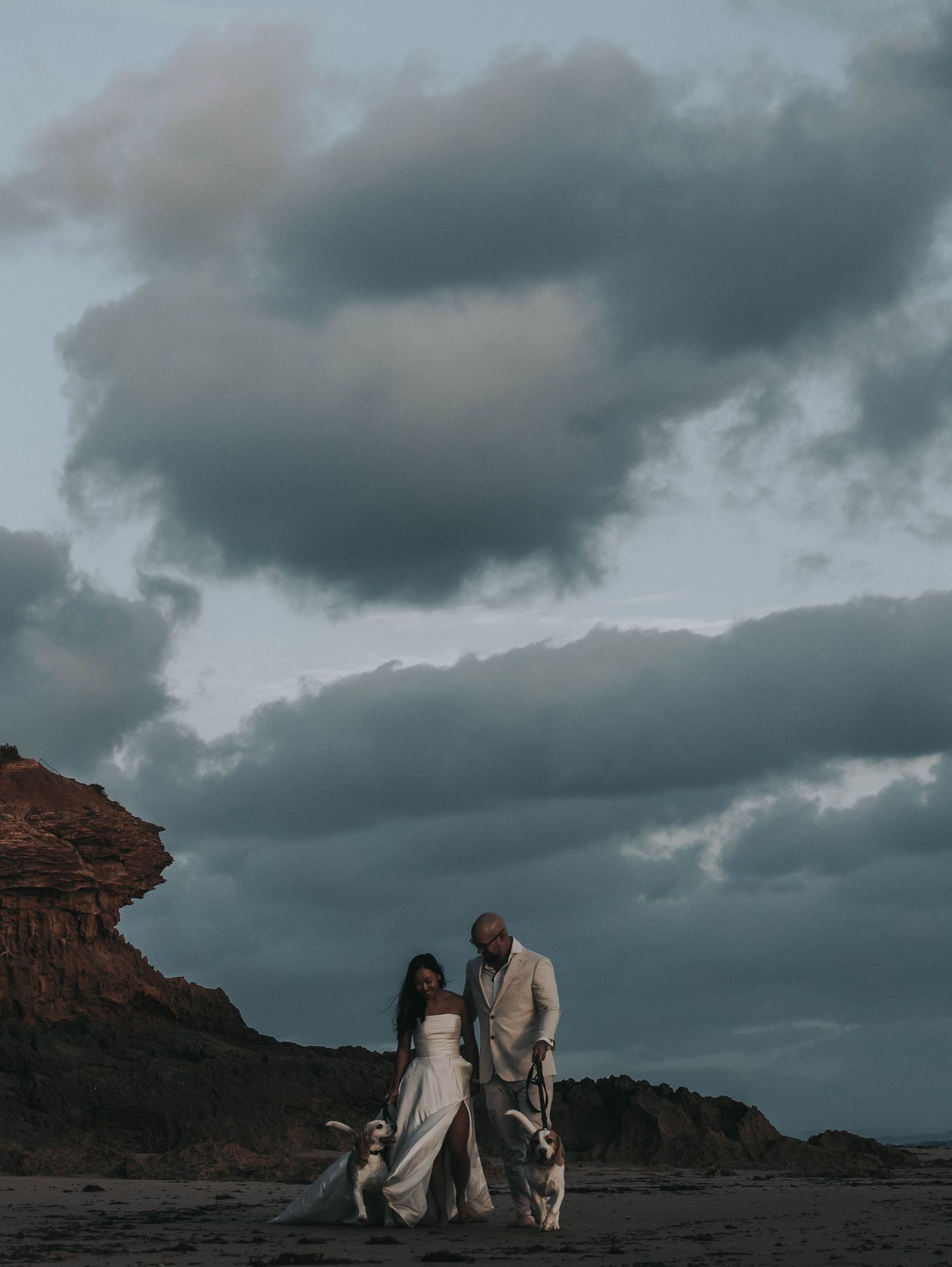the stormy clouds creating a stunning backdrop to emphasise the beauty of husband and wife