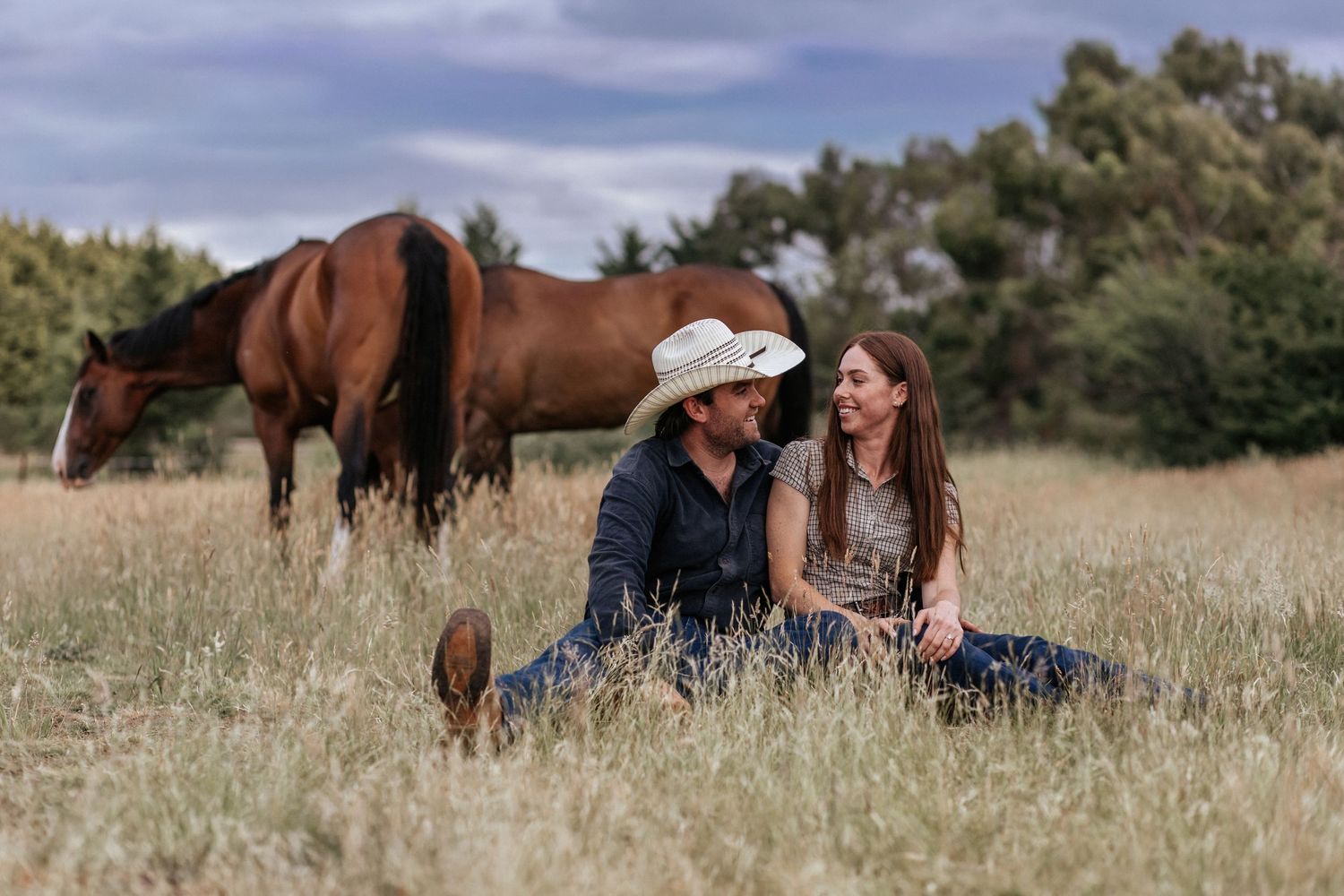 Cowboy and cowgirl enjoying a moment together in the field