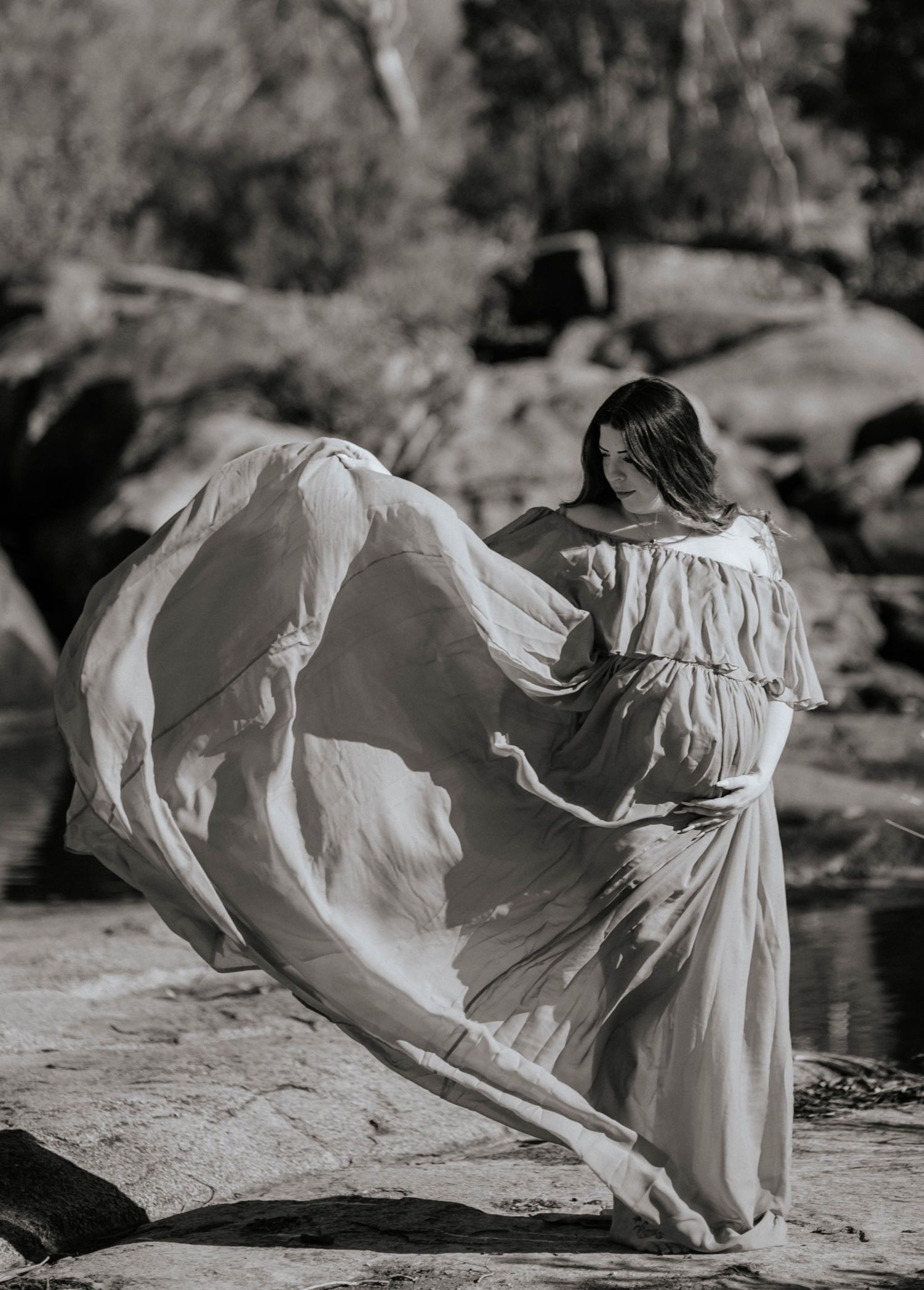 a floating dress at the creekside capturing baby bump glow