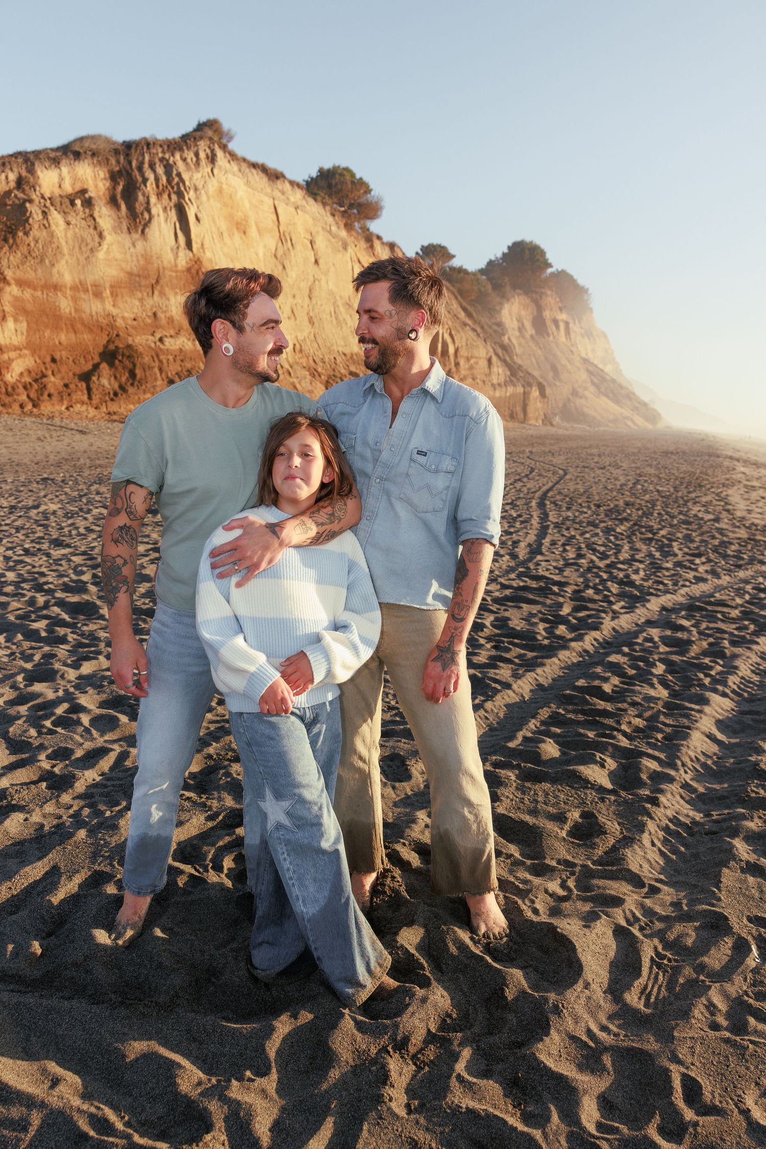 Parent holding a young child during a family photography session on a rocky Northern California beach.