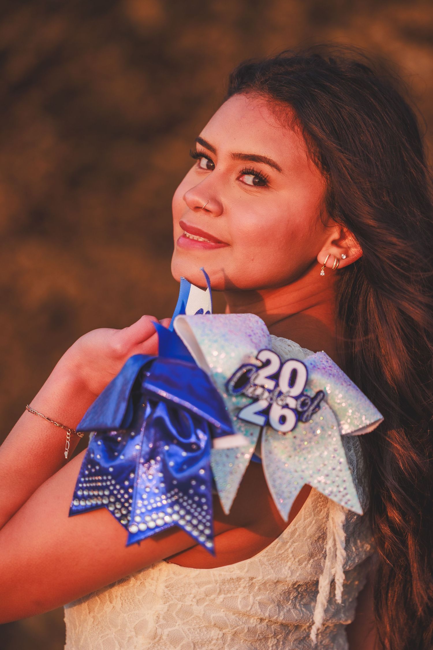 High school senior posing in a cheer uniform during an outdoor senior portrait session.